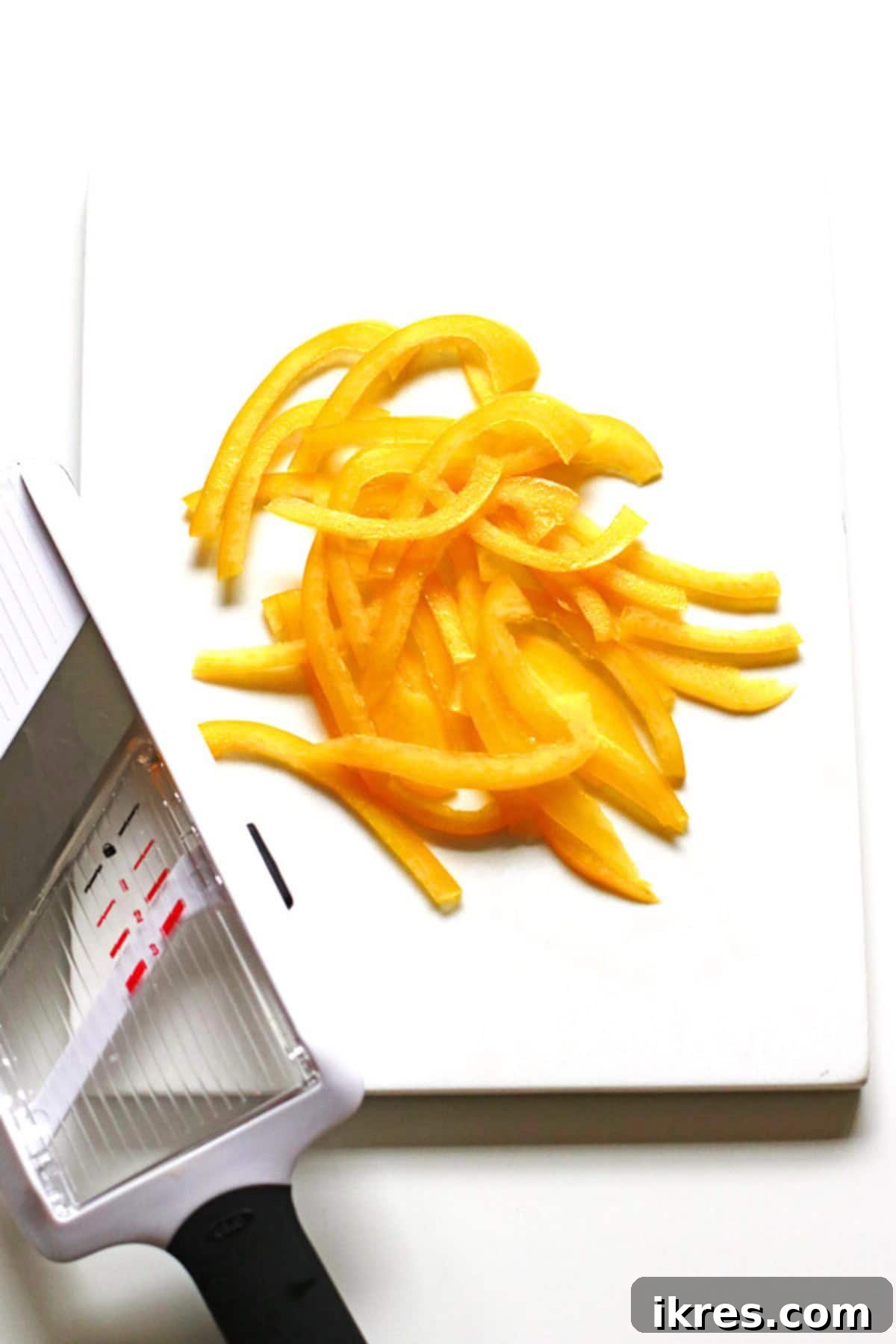 Supreme Pizza Perfection 3 Sliced sweet bell peppers on white cutting board