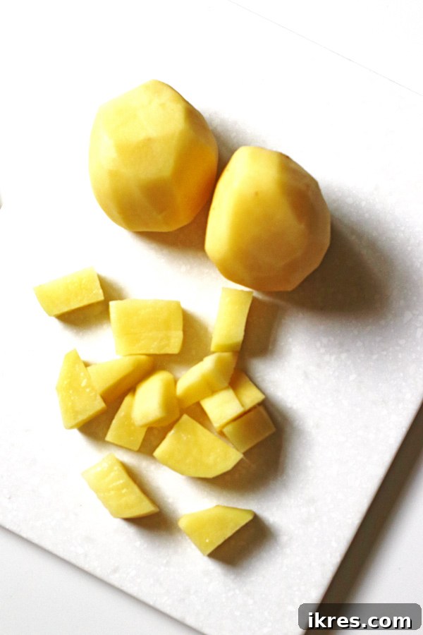 Golden Mashed Potato Bake 4 Potatoes sliced on cutting board