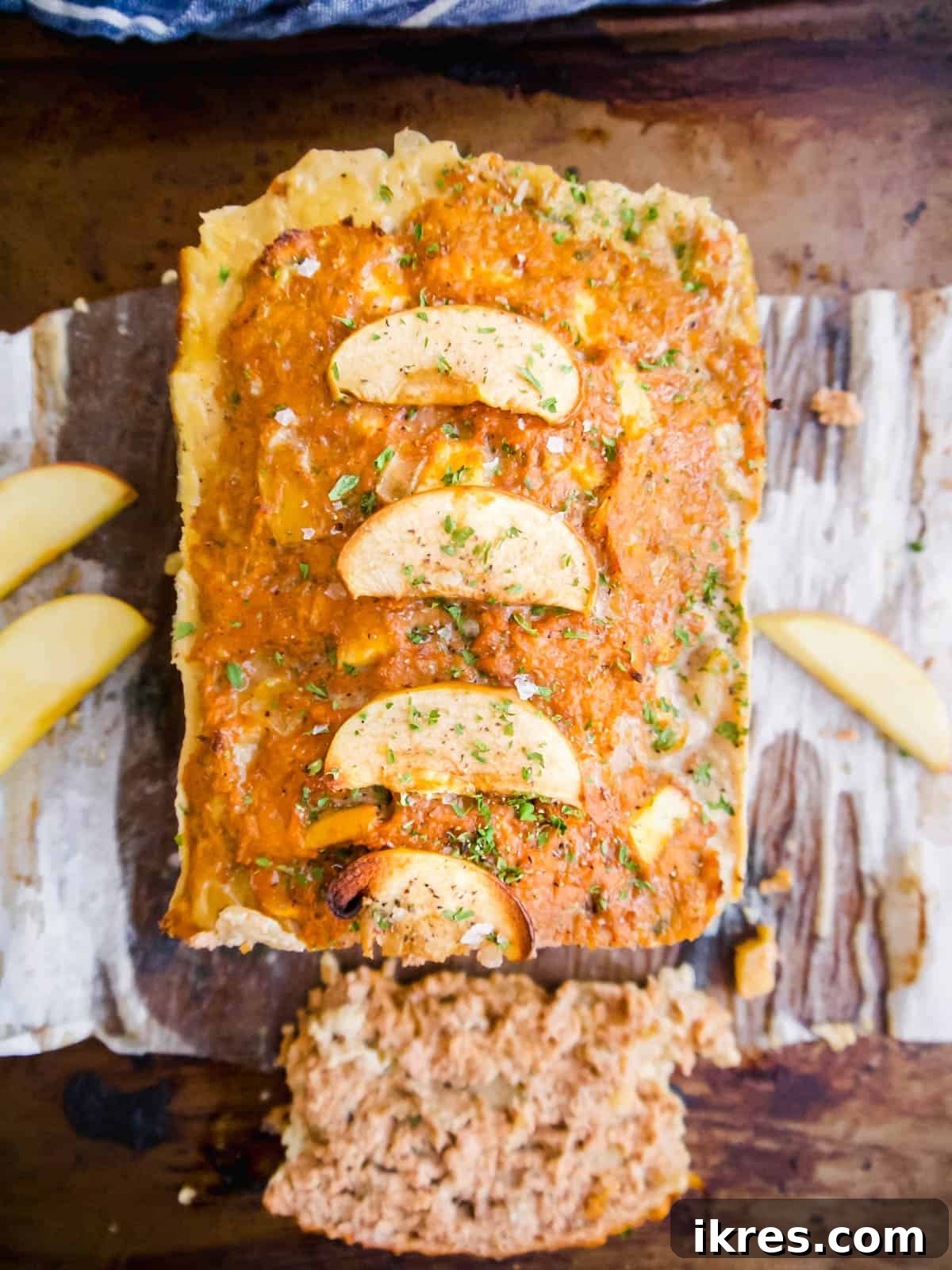 Freshly cooked turkey apple meatloaf in a loaf pan, ready to be sliced.