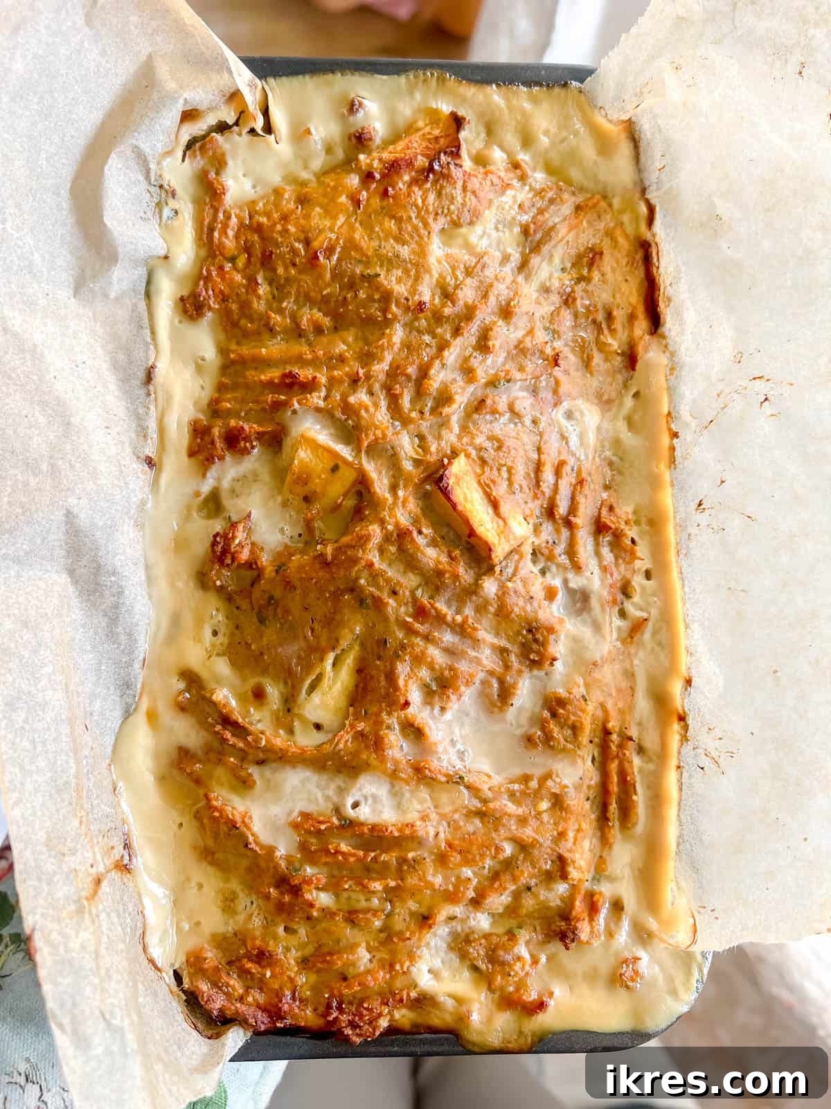 The fully baked turkey apple meatloaf, golden brown and perfectly cooked, resting in the loaf pan after removal from the oven.