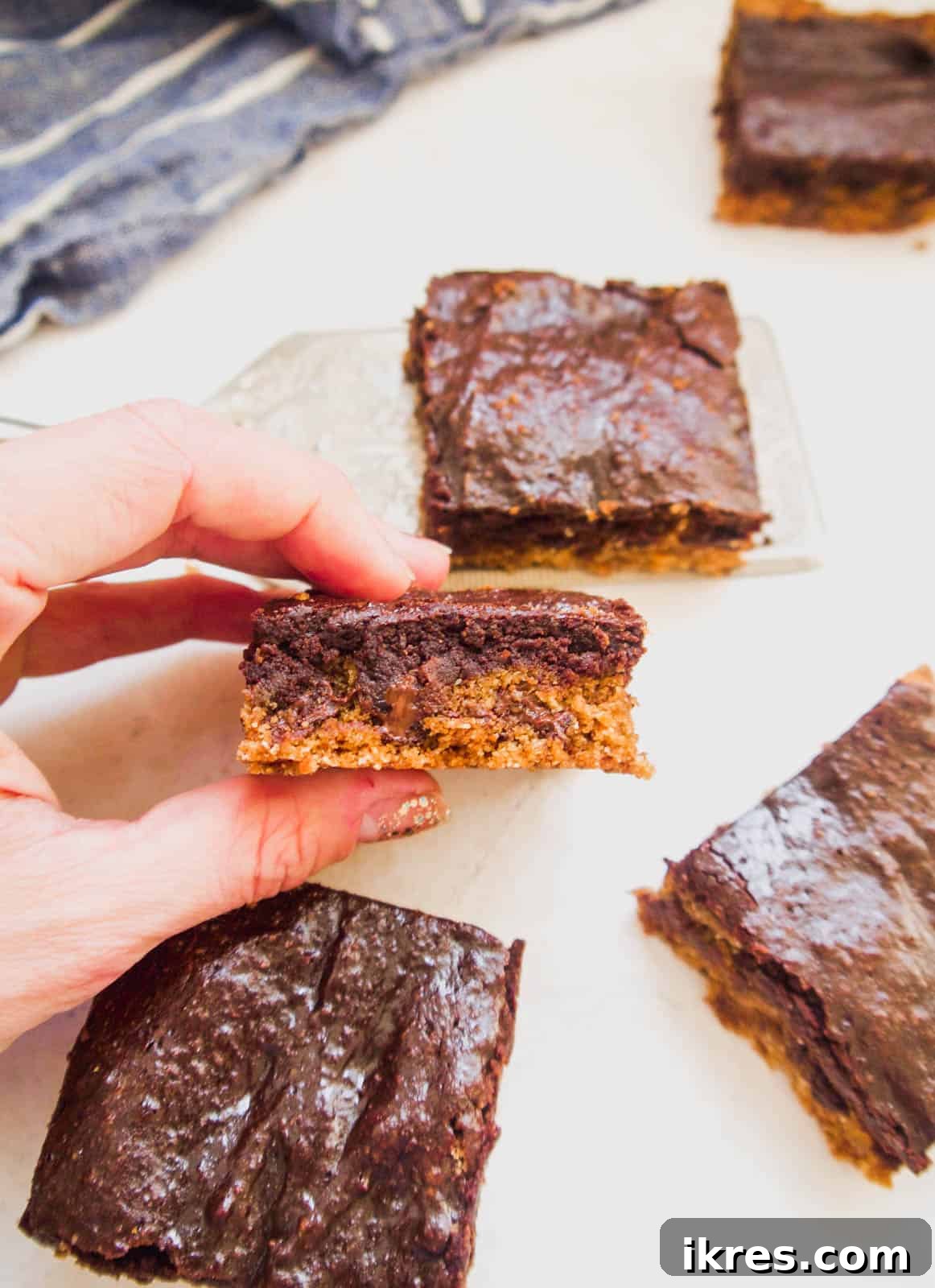 A beautifully cut slice of a healthy brookie recipe, showing the distinct layers.