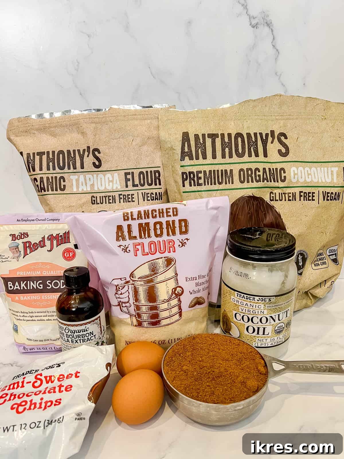 Collection of dry and wet ingredients laid out for the cookie layer of gluten-free brookies.