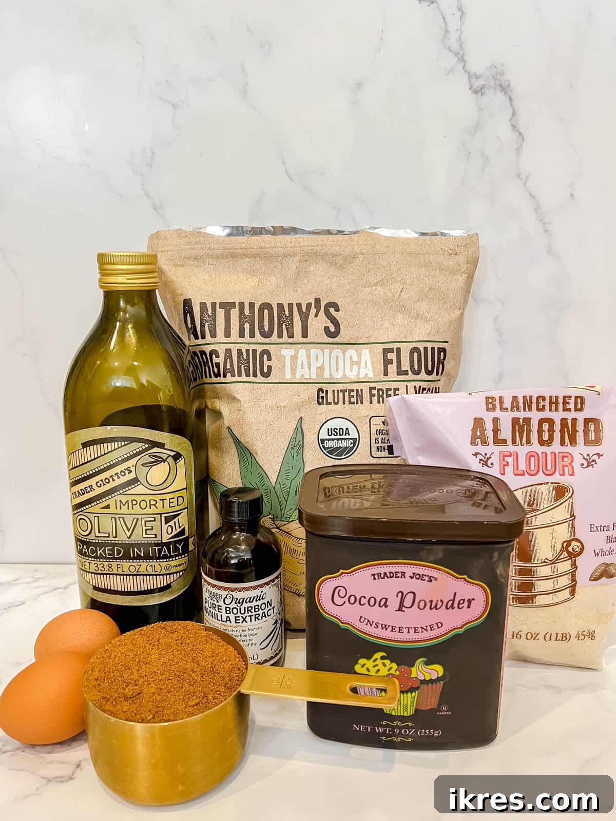 Assortment of rich chocolate and baking essentials for the brownie layer of healthy brookies.