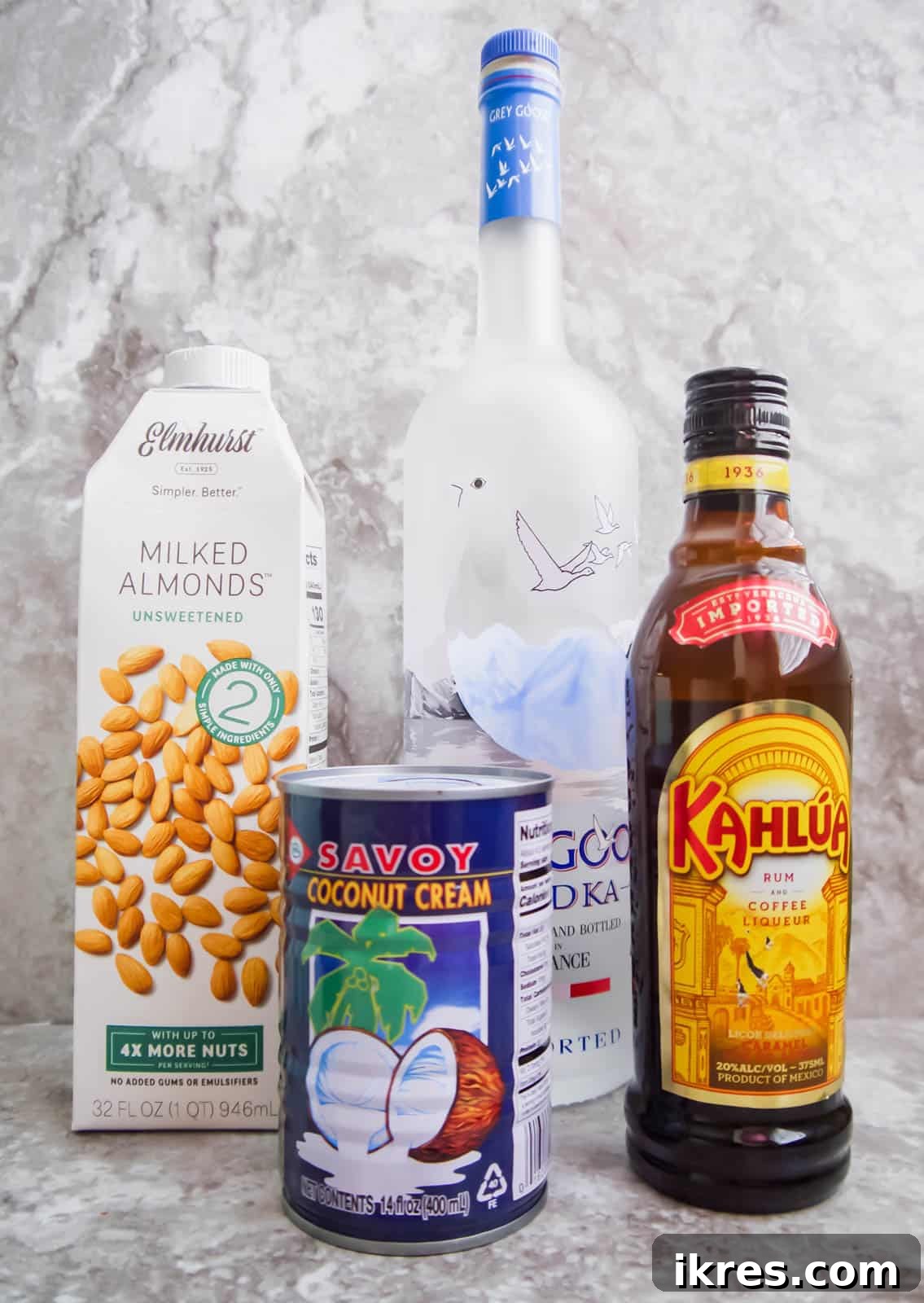 Silken White Russian 4 All the ingredients neatly arranged for making a dairy-free White Russian: coffee liqueur, vodka, almond milk, and coconut cream.