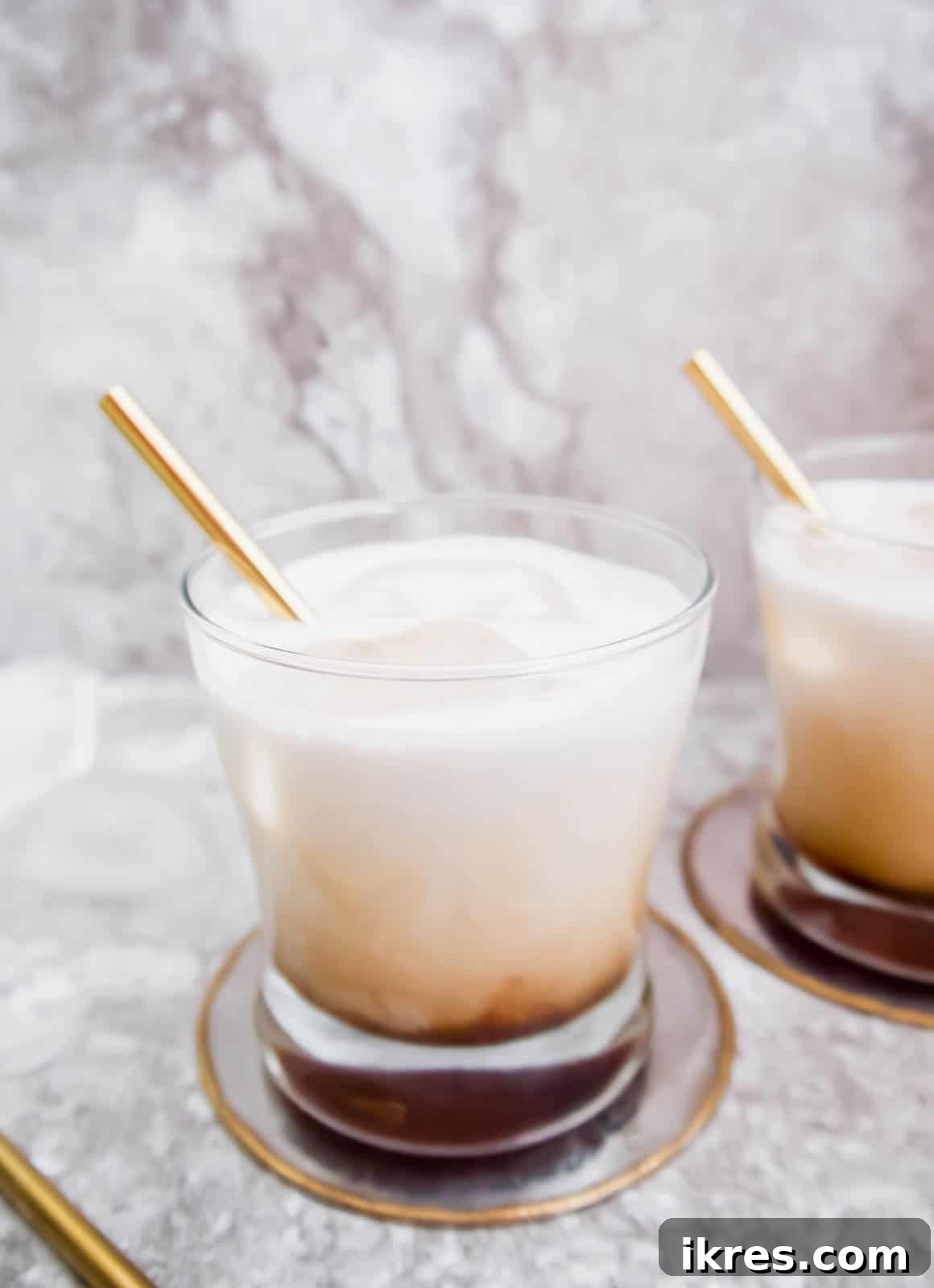 Silken White Russian 6 A close-up side view of a Dairy-Free White Russian cocktail in a glass, showing its smooth, layered appearance.