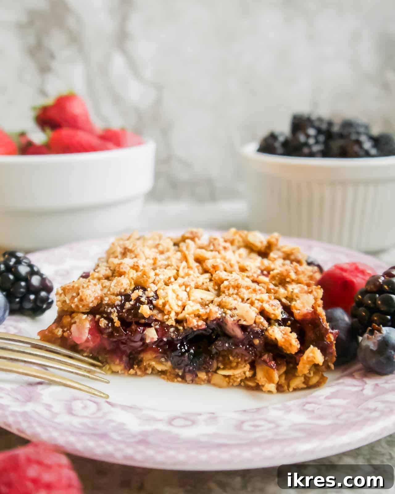 Delicious Gluten-Free Dairy-Free Berry Oat Bars 2 Vibrant mixed berry oat crumble bars ready to be served, showcasing layers of fruit and oat goodness.