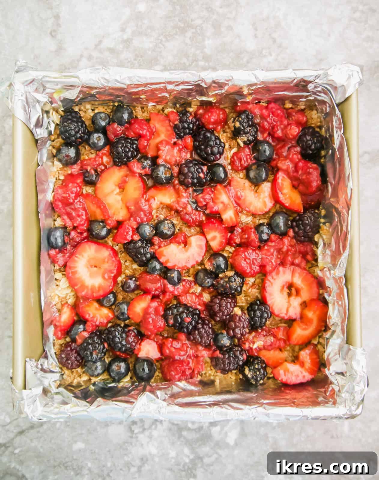 Delicious Gluten-Free Dairy-Free Berry Oat Bars 6 The mixed berry filling spread over the oat base in the pan.