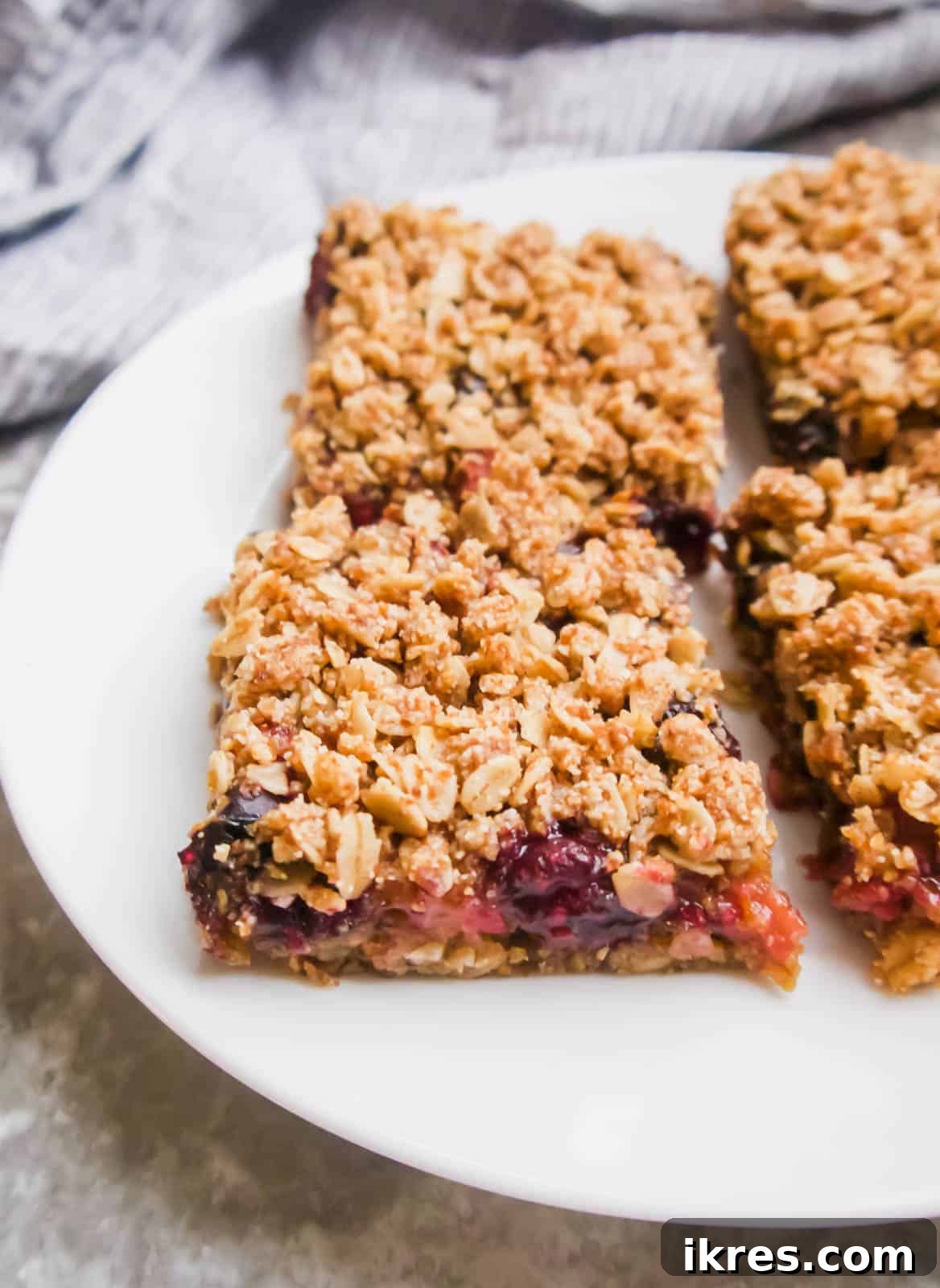 Delicious Gluten-Free Dairy-Free Berry Oat Bars 9 Perfectly cut squares of oat berry bars arranged on a plate, ready to be enjoyed.