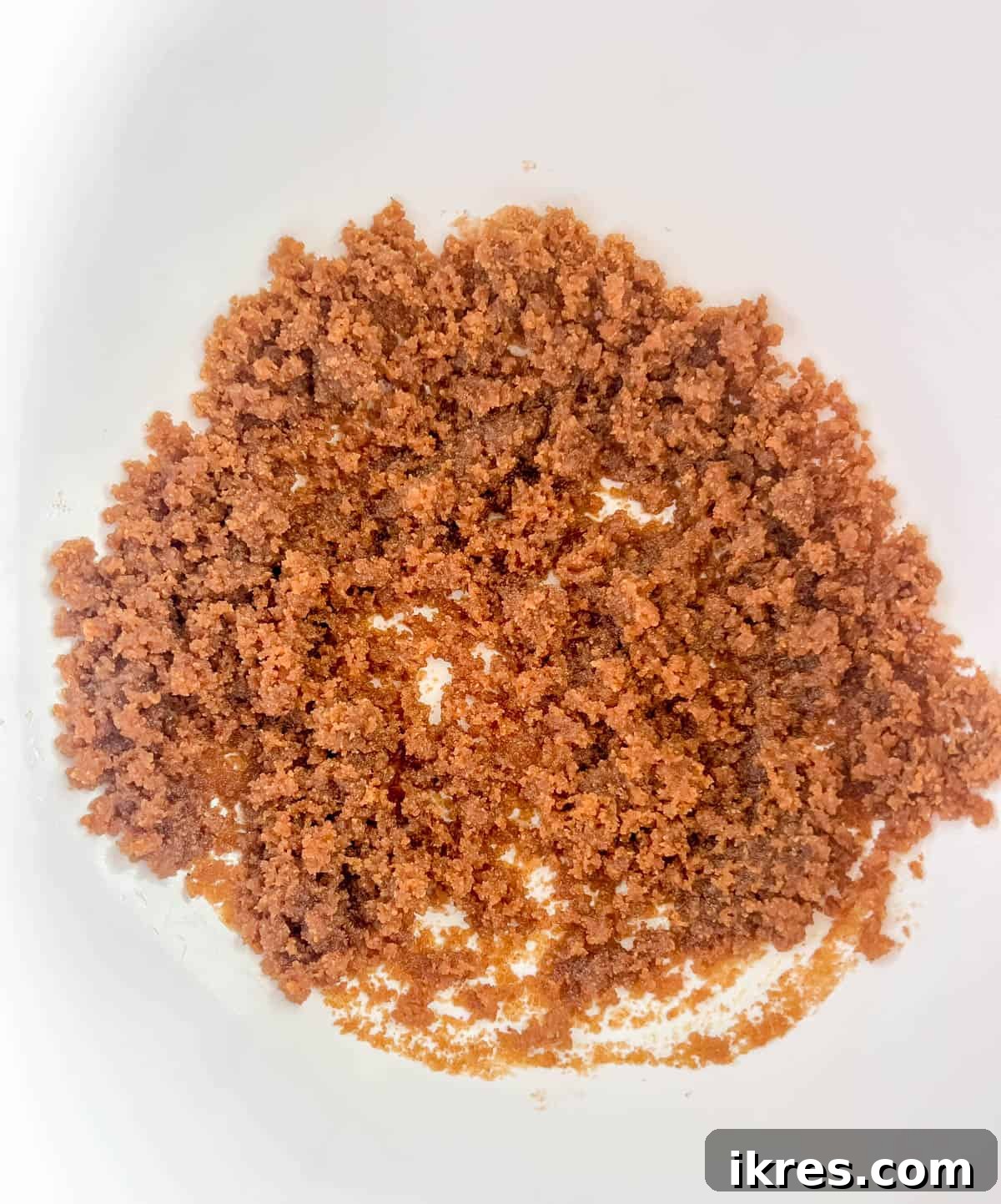 Coconut sugar and olive oil in a mixing bowl, ready to be combined.