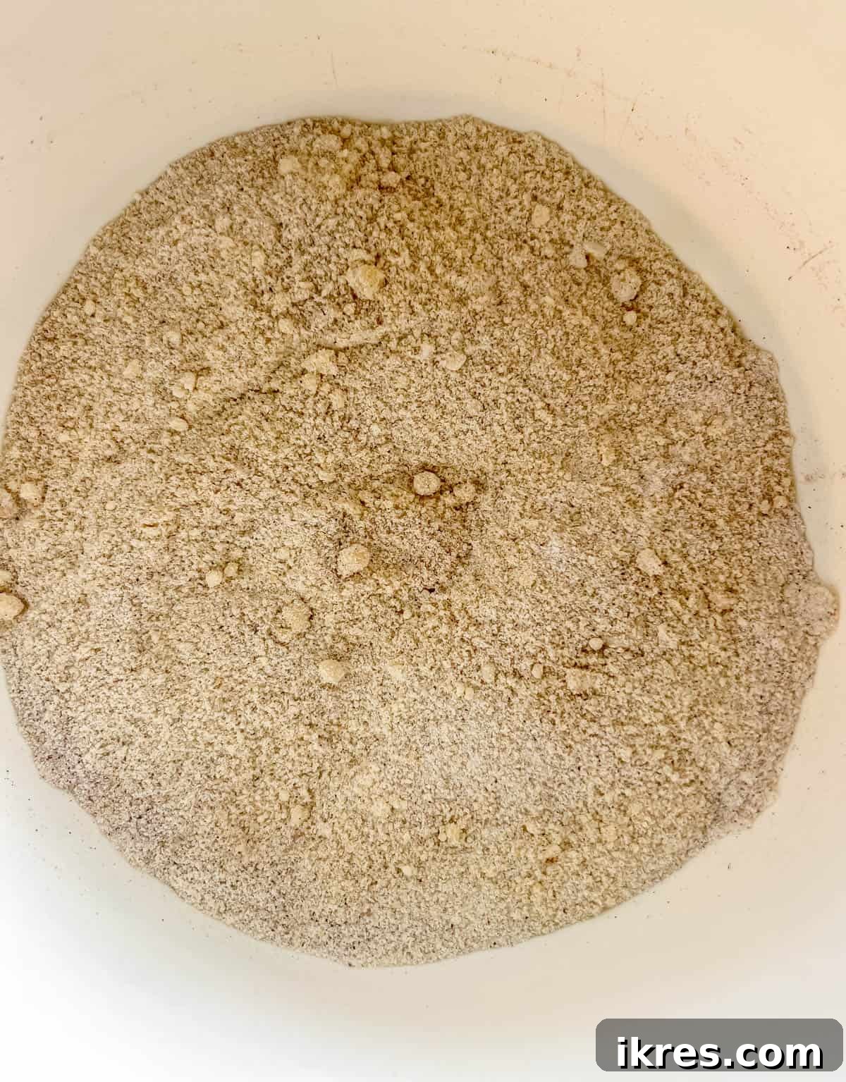 A bowl containing almond flour, tapioca flour, coconut flour, baking soda, salt, and cinnamon – all the dry ingredients for the paleo banana bread.