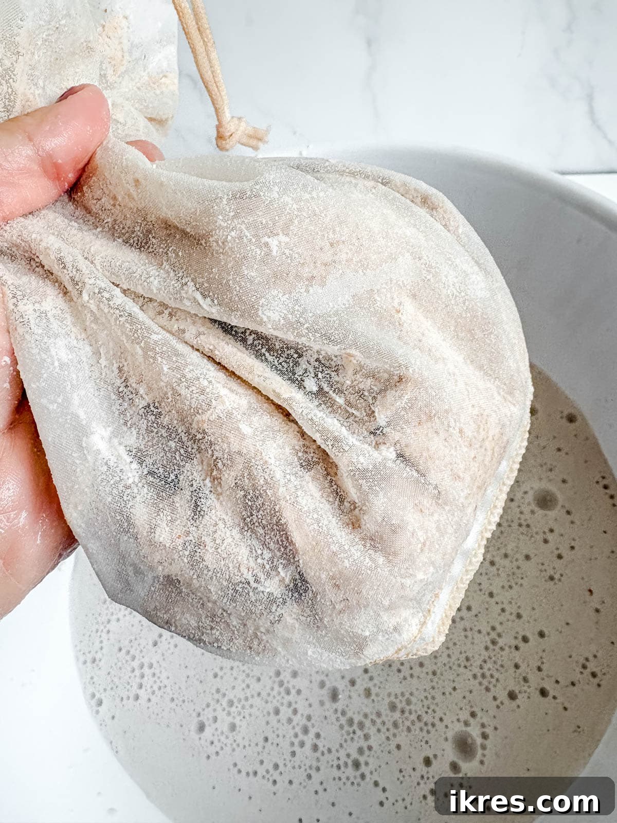 Homemade Vegan Strawberry Almond Milk 12 Dry, clumped almond pulp remaining in the nut milk bag after straining.