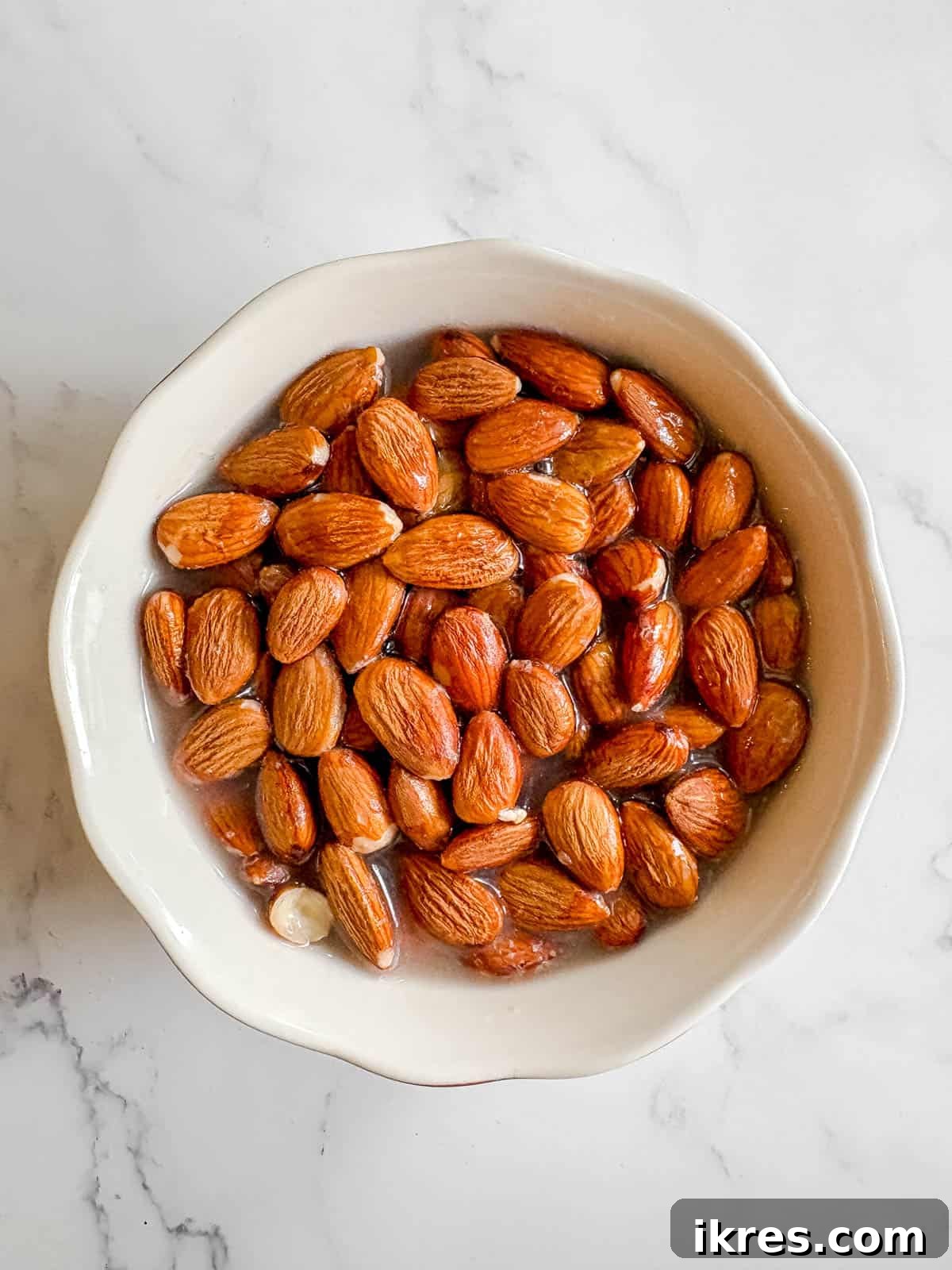 Homemade Vegan Strawberry Almond Milk 3 Raw almonds soaking in a bowl of water overnight.
