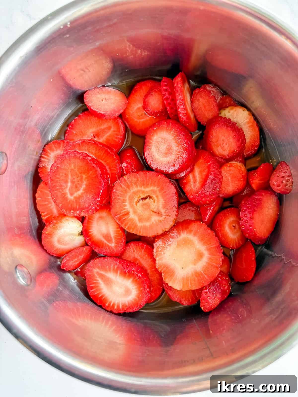 Homemade Vegan Strawberry Almond Milk 4 Sliced fresh strawberries, maple syrup, vanilla, and water added to a saucepan.