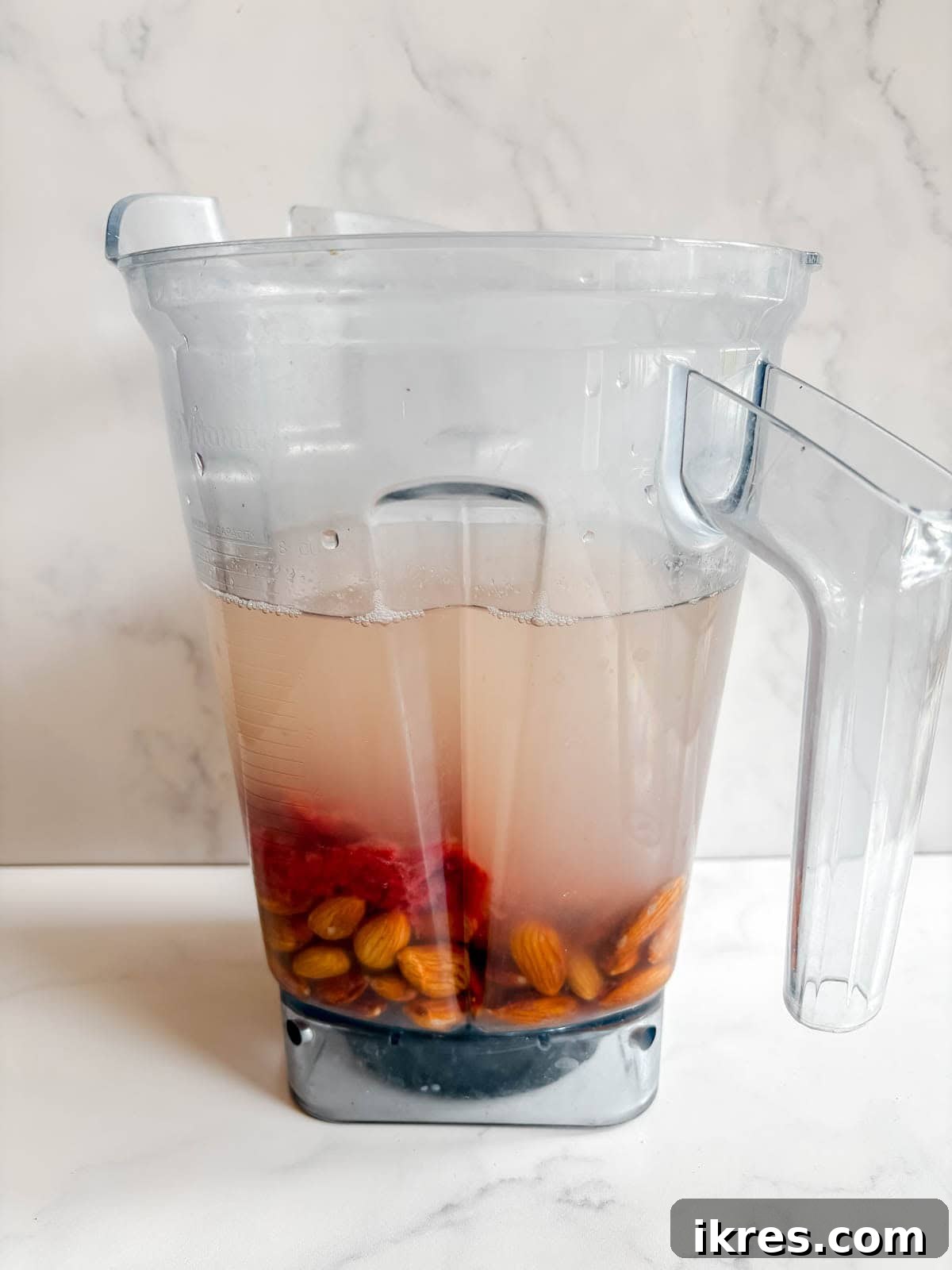 Homemade Vegan Strawberry Almond Milk 8 Soaked almonds, filtered water, and the reserved strawberry pulp in a high-speed blender.