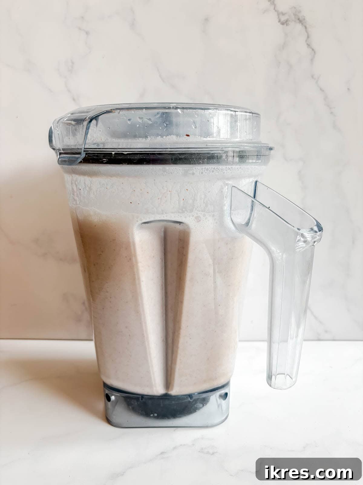 Homemade Vegan Strawberry Almond Milk 9 Almonds, water, and strawberry pulp being blended into a milky consistency.
