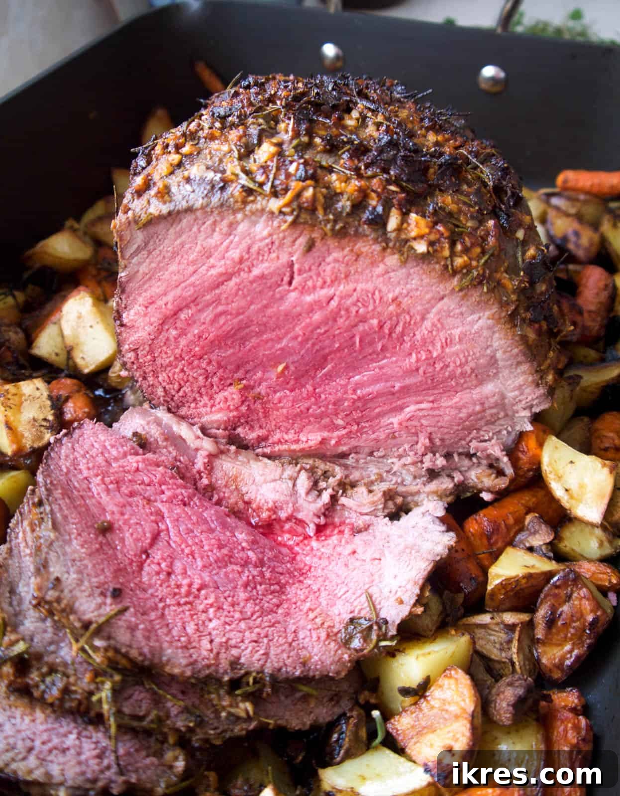 Savory Garlic Herb Shoulder Roast 8 A beautifully roasted beef shoulder roast, just out of the oven, expertly sliced to reveal its juicy interior.