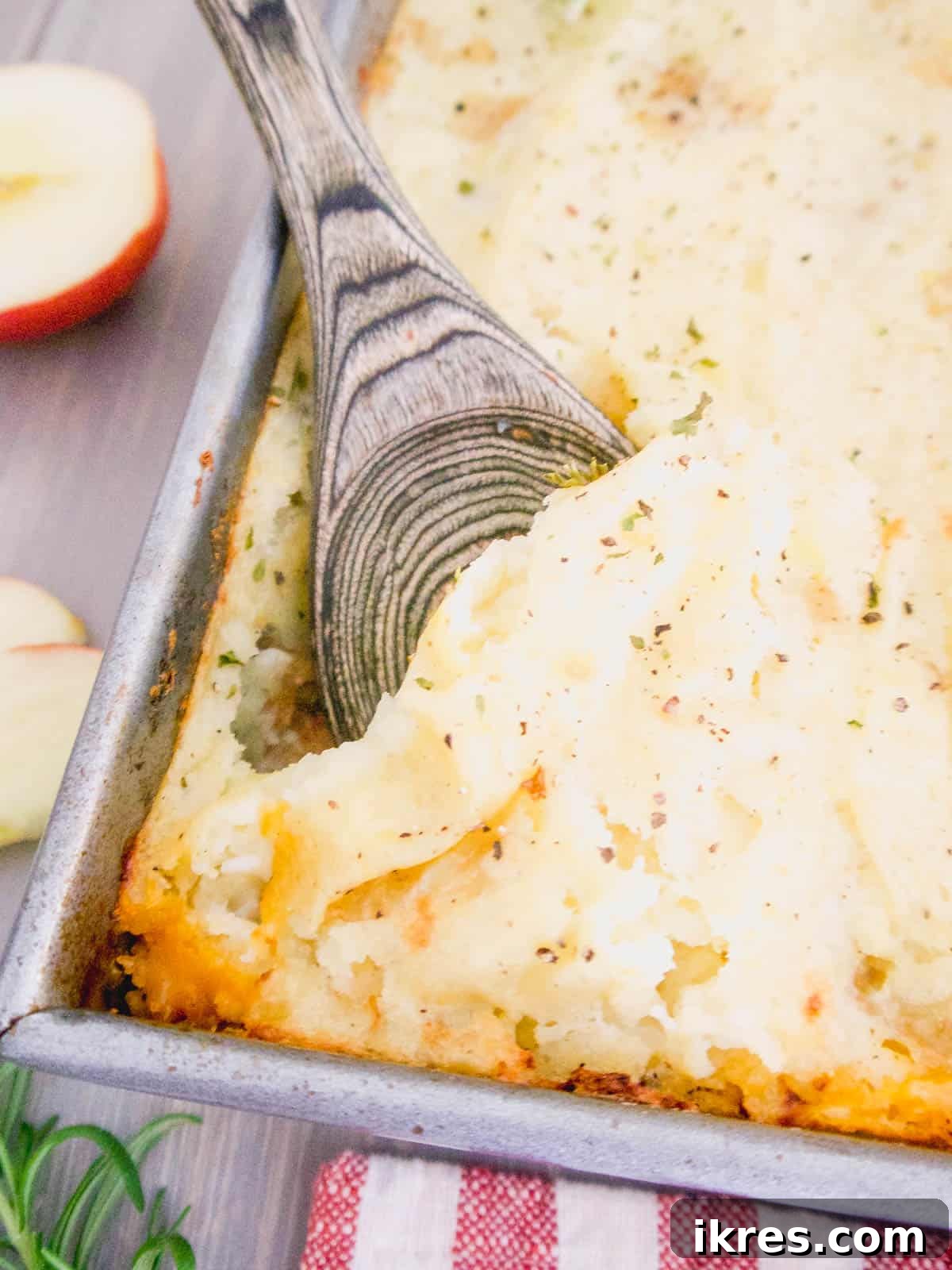Healthy turkey shepherd's pie with a serving spoon nestled in the dish, ready to be scooped.