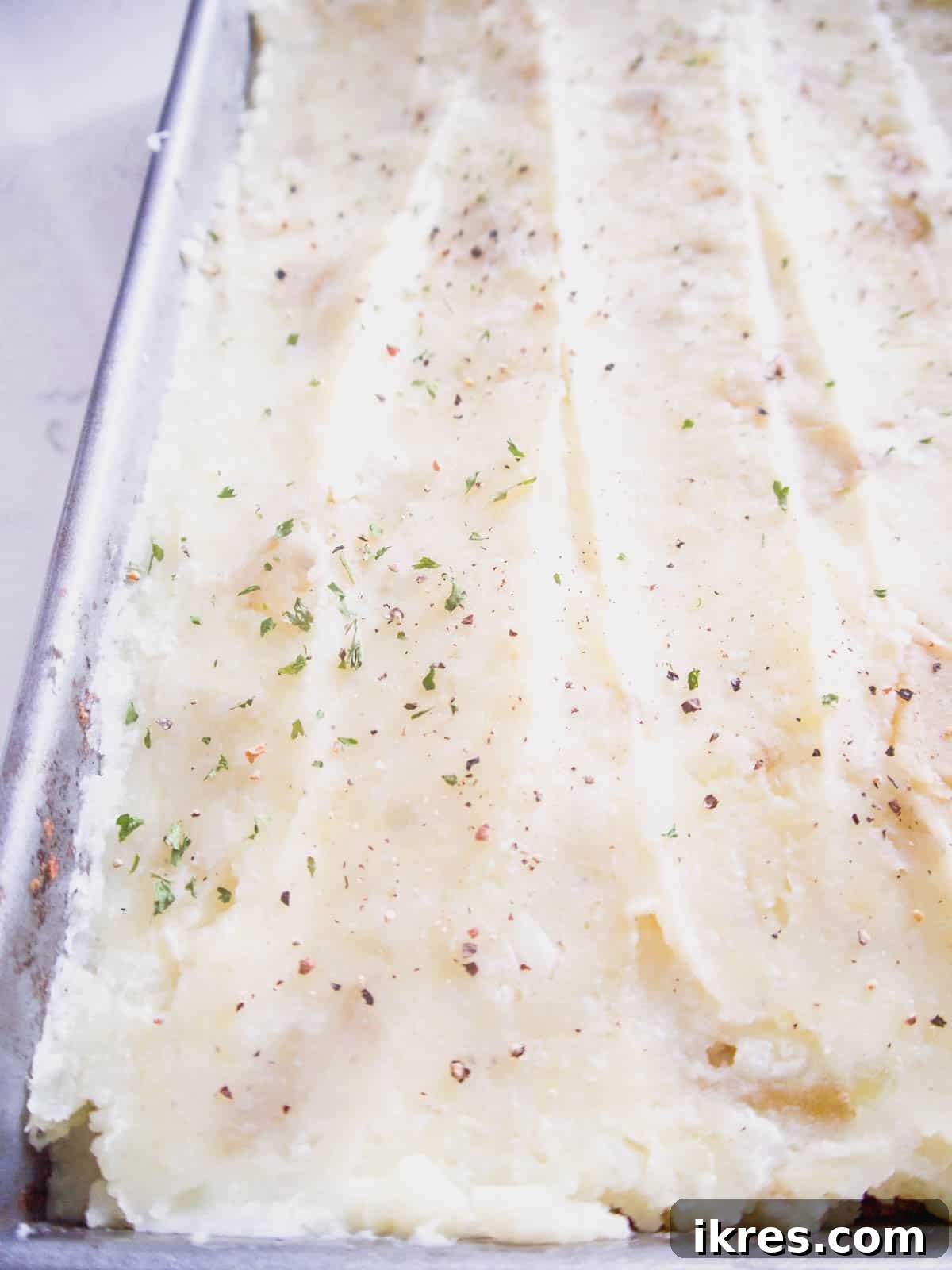 The fully topped shepherd's pie with a smooth layer of cauliflower and potato mash.