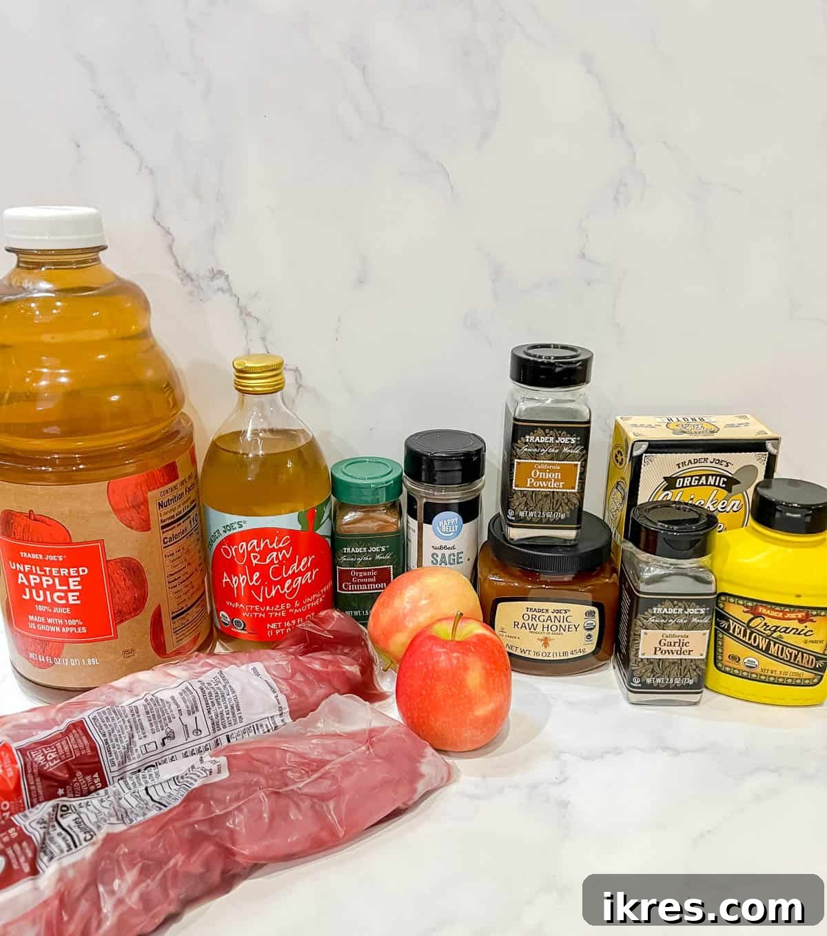 Fall-Apart Apple Pulled Pork 3 A flat lay photograph showcasing all the fresh and dry ingredients required to prepare a succulent slow cooker apple pulled pork, including pork shoulder, apples, spices, and liquids.