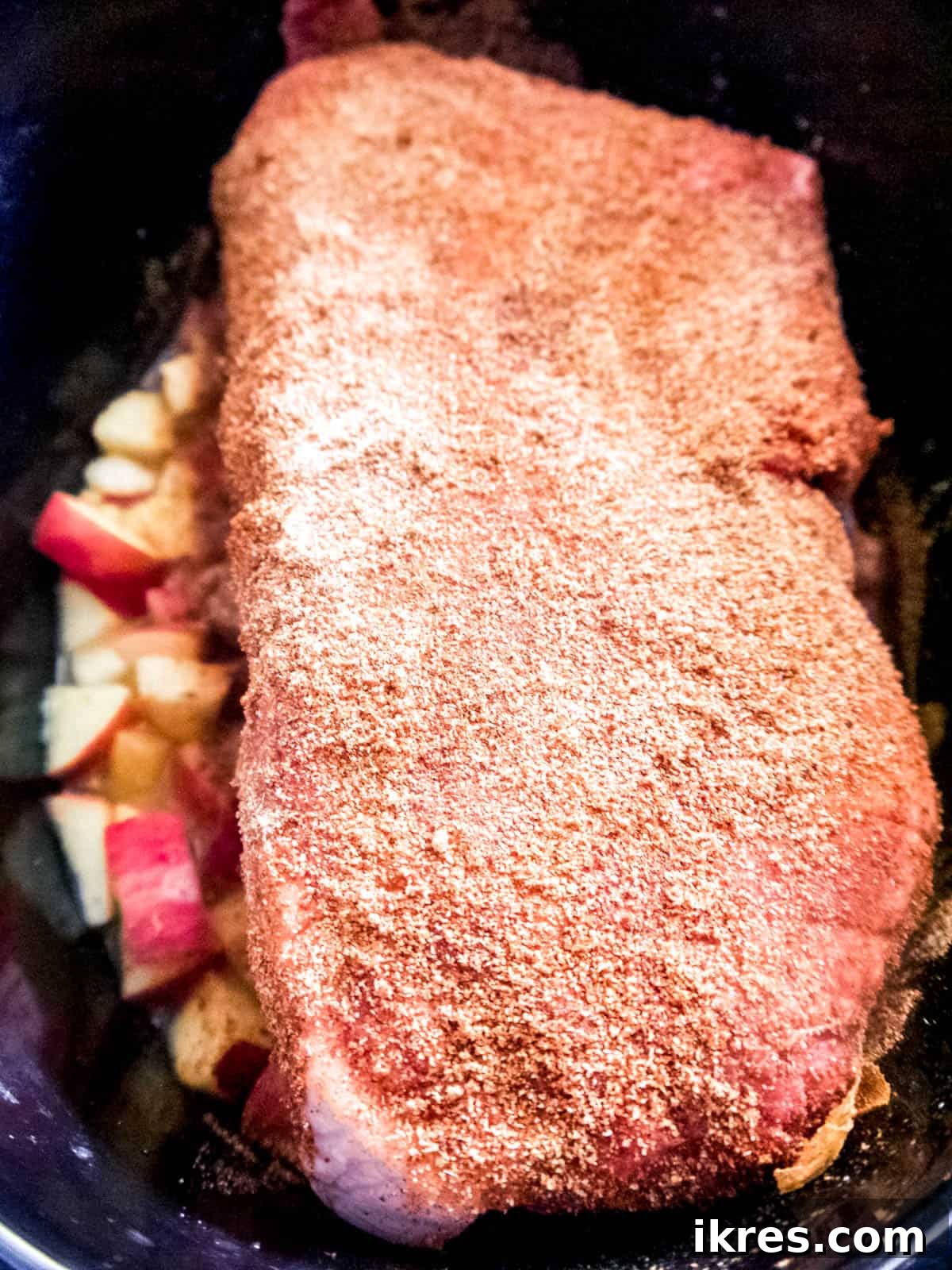 Fall-Apart Apple Pulled Pork 5 All the raw ingredients, including the pork shoulder roast, diced apples, and liquids, are assembled in the slow cooker before cooking the apple pulled pork.