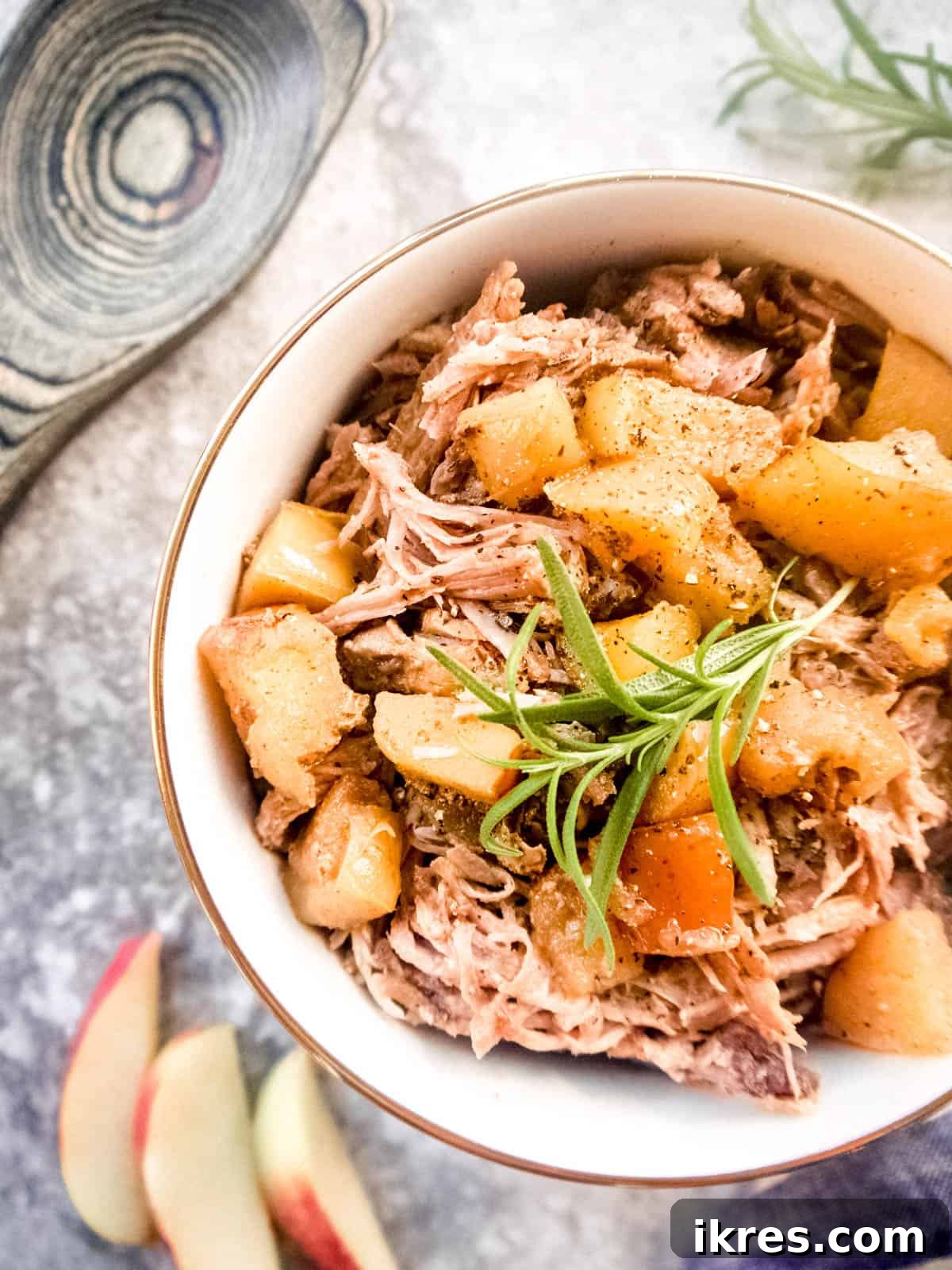 Fall-Apart Apple Pulled Pork 6 A close-up shot of tender apple cider vinegar pulled pork, beautifully shredded and served in a bowl, highlighting its rich texture and savory aroma.