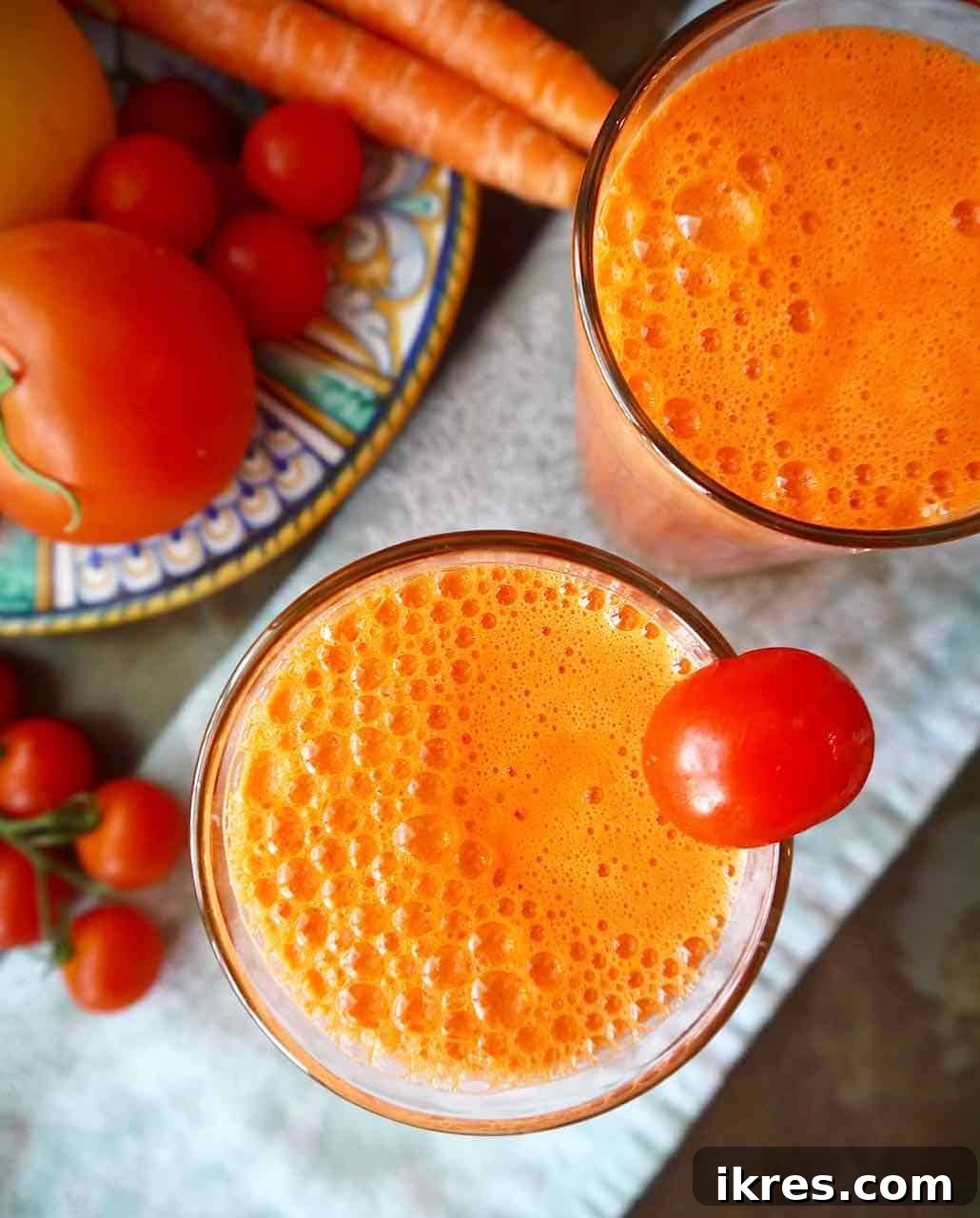 Aerial view of tomato carrot juice in a glass, vibrant and inviting.