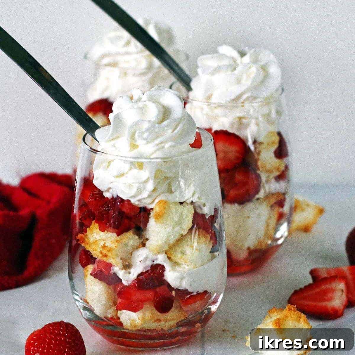 Strawberry Angel Delight 13 Two angel food cake strawberry shortcakes in stemless wine glasses topped with whipped cream.