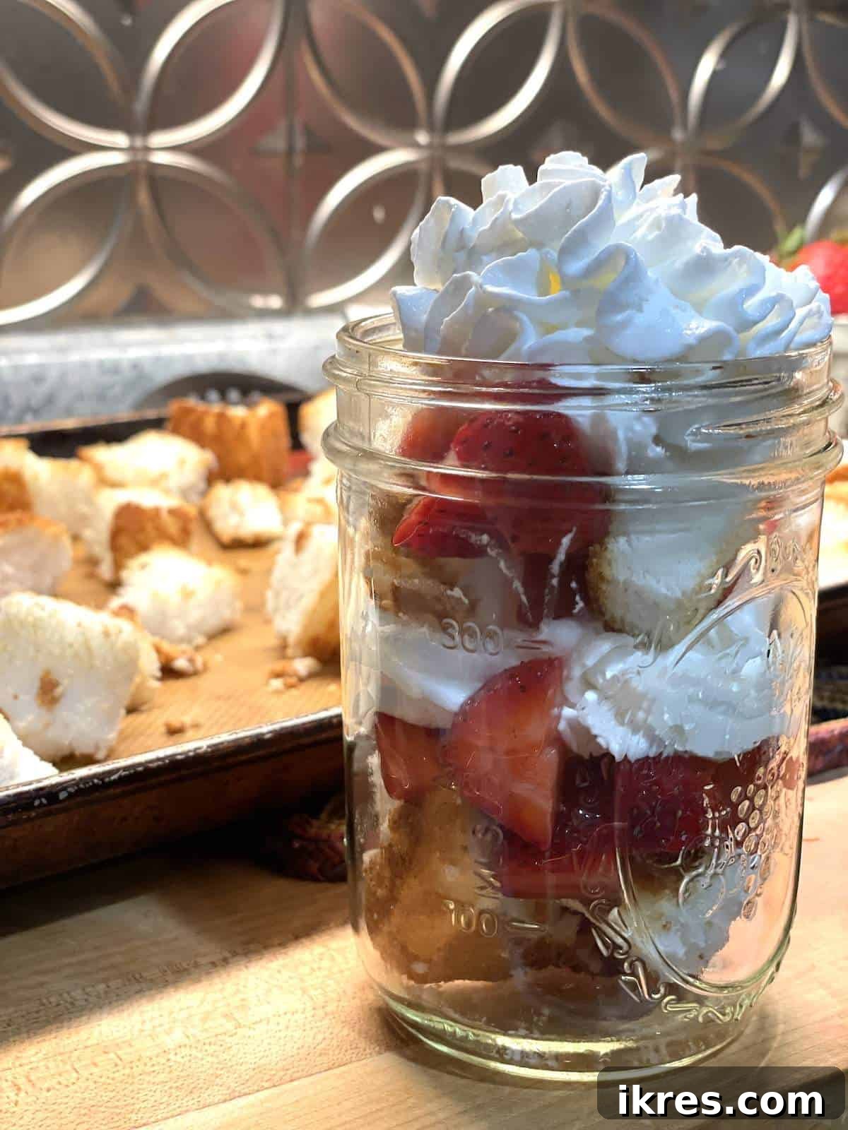 Strawberry Angel Delight 15 A jar of layers of angel food cake strawberry shortcake in a mason jar.