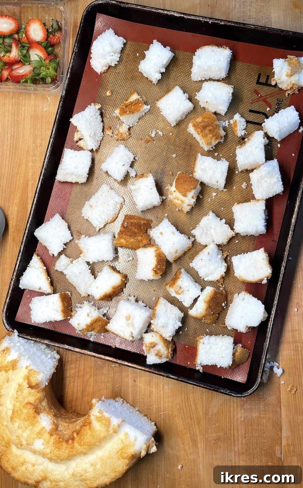 Strawberry Angel Delight 7 Angel food cake cut into cubes on a bake sheet before toasting to make shortcakes.