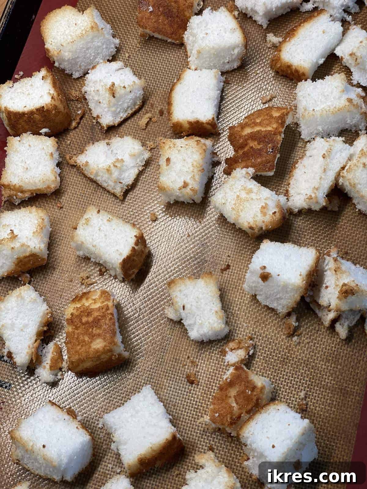 Strawberry Angel Delight 10 Toasted angel food cake cubes on a baking sheet.