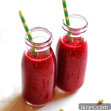 Tropical Cherry Pineapple Bliss 8 Two cherry pineapple smoothies in small bottles with green and yellow straws.