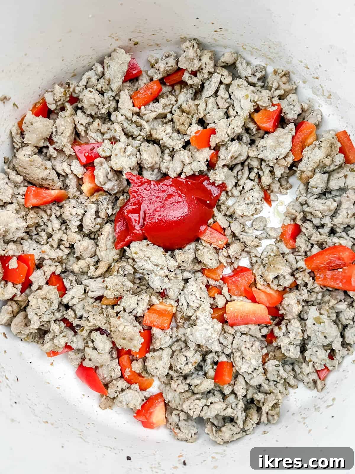 One Pot Wonder Ground Turkey Rice and Beans Gluten Free 7 Tomato paste and apple cider vinegar added to the center of the pan with turkey mixture.