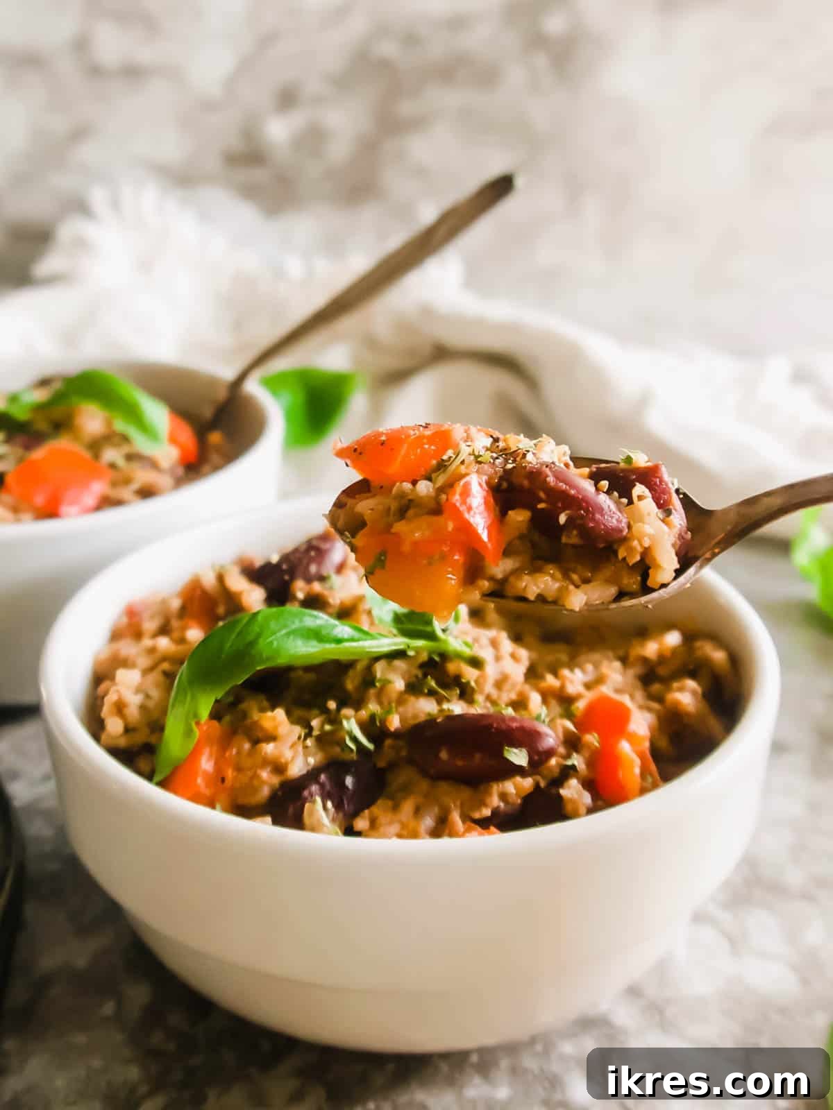 One Pot Wonder Ground Turkey Rice and Beans Gluten Free 10 Spoon being lifted from a bowl filled with the hearty turkey, rice, and beans skillet.