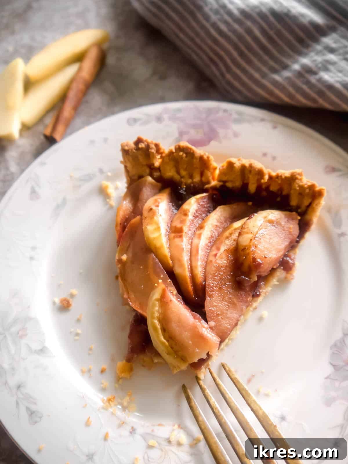 Slice of almond flour apple tart on a plate, ready to be served.