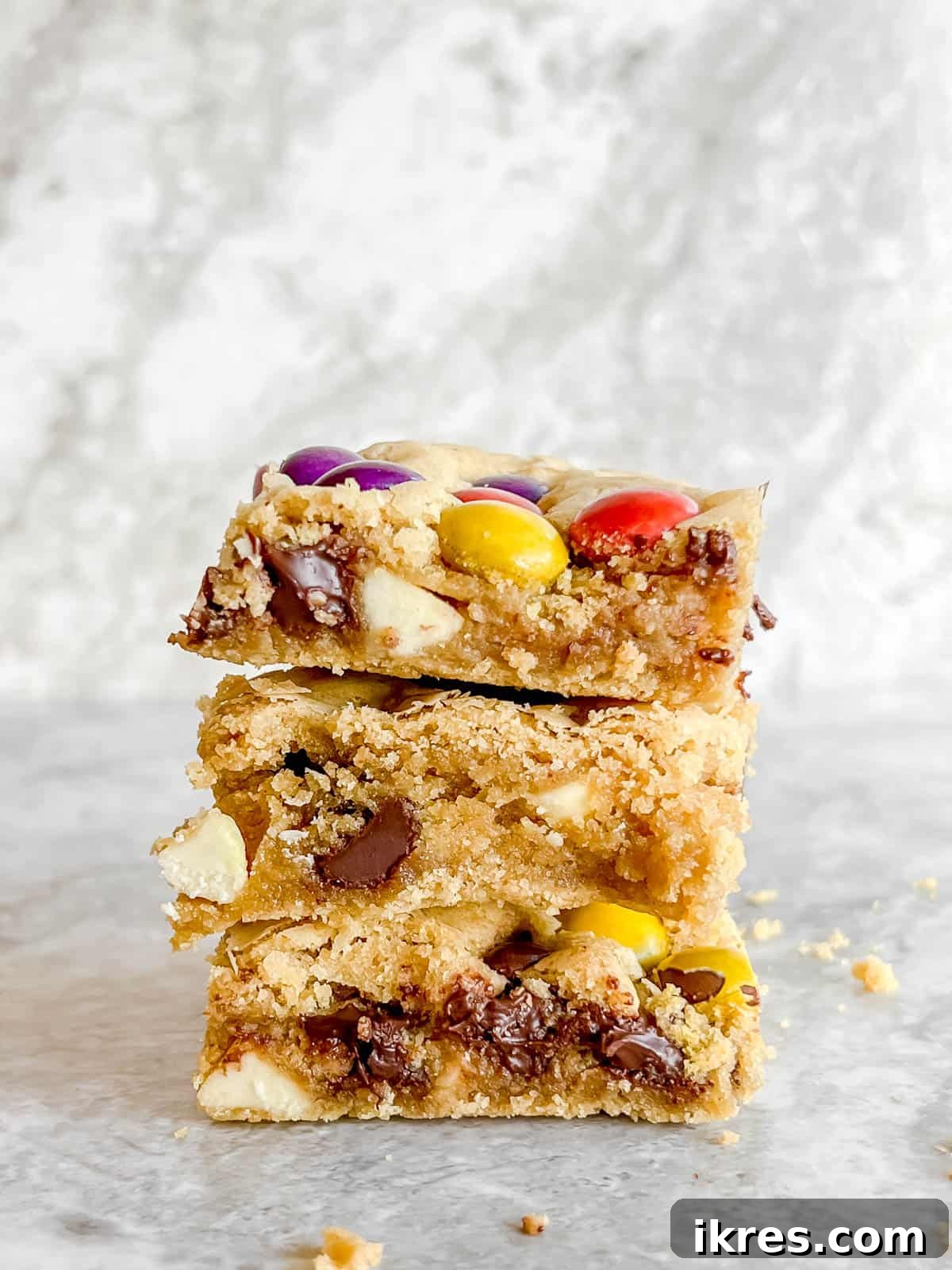 Ultimate Gluten-Free Dairy-Free Chocolate Chip Cookie Bars 2 Gluten Free Cookie Bars stacked on top of each other, showcasing their gooey texture.