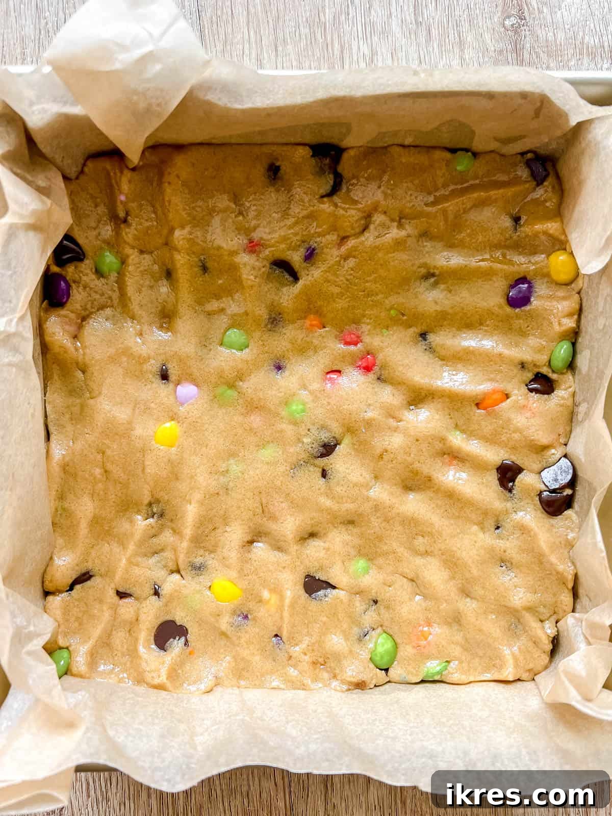 Ultimate Gluten-Free Dairy-Free Chocolate Chip Cookie Bars 8 Gluten-free cookie bars pressed into an 8x8 inch pan before baking.