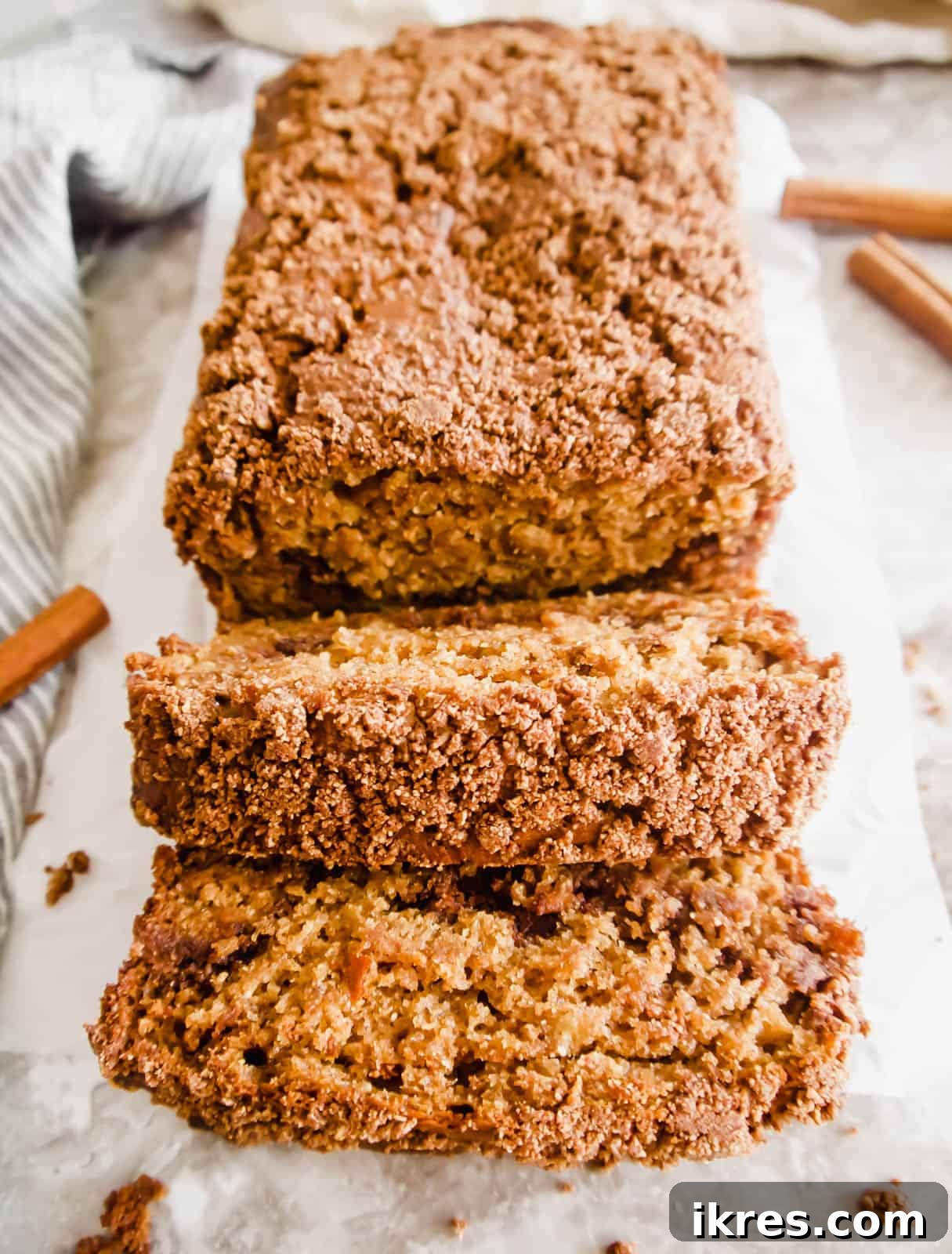 Paleo Gluten-Free Cinnamon Swirl Banana Bread Coffee Cake 2 A warm slice of gluten-free coffee cake banana bread fresh out of the oven, revealing its moist texture and streusel layers.