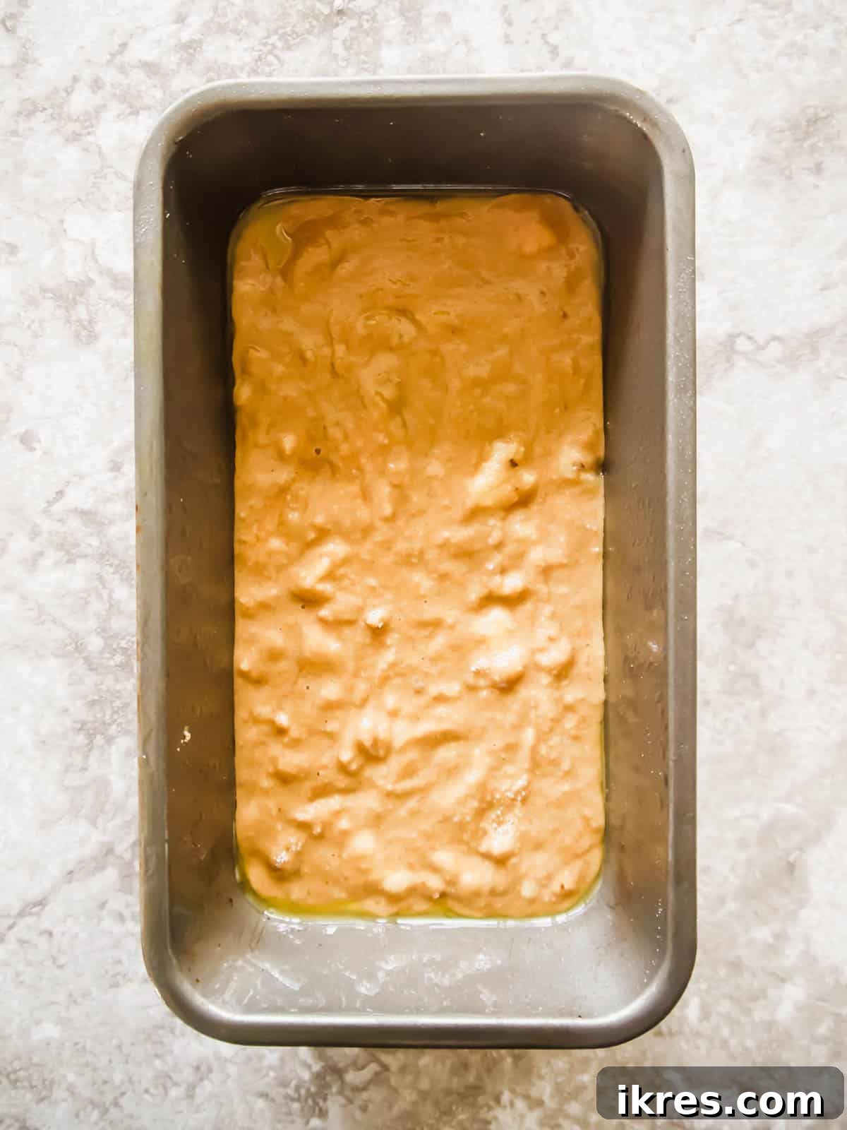 Paleo Gluten-Free Cinnamon Swirl Banana Bread Coffee Cake 4 Banana bread coffee cake batter in a loaf tin, ready for layering.