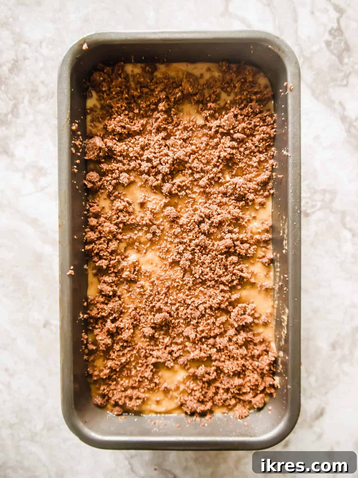Paleo Gluten-Free Cinnamon Swirl Banana Bread Coffee Cake 7 Gluten free banana bread with streusel on top, showing the final raw assembly.