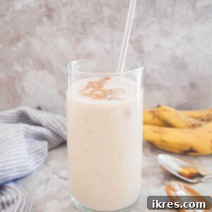 Dairy-free Banana Maple Smoothie, a blend of banana, maple syrup, and yogurt, topped with almond butter.
