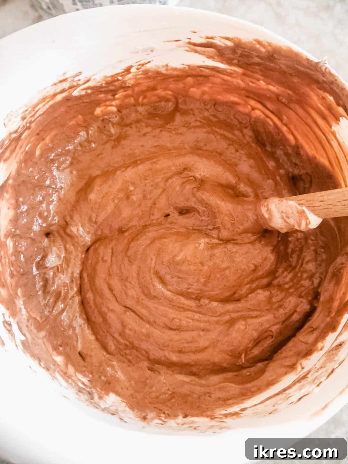 Decadent Gluten-Free Dairy-Free Chocolate Mousse Truffles 7 Thawed CocoWhip and cooled melted chocolate expertly folded together in a bowl, creating a smooth, homogenous chocolate mousse mixture.
