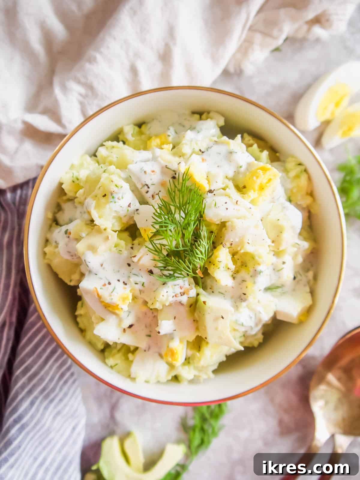 Dill Ranch Potato Salad with Avocado and Eggs, garnished with fresh dill sprigs.