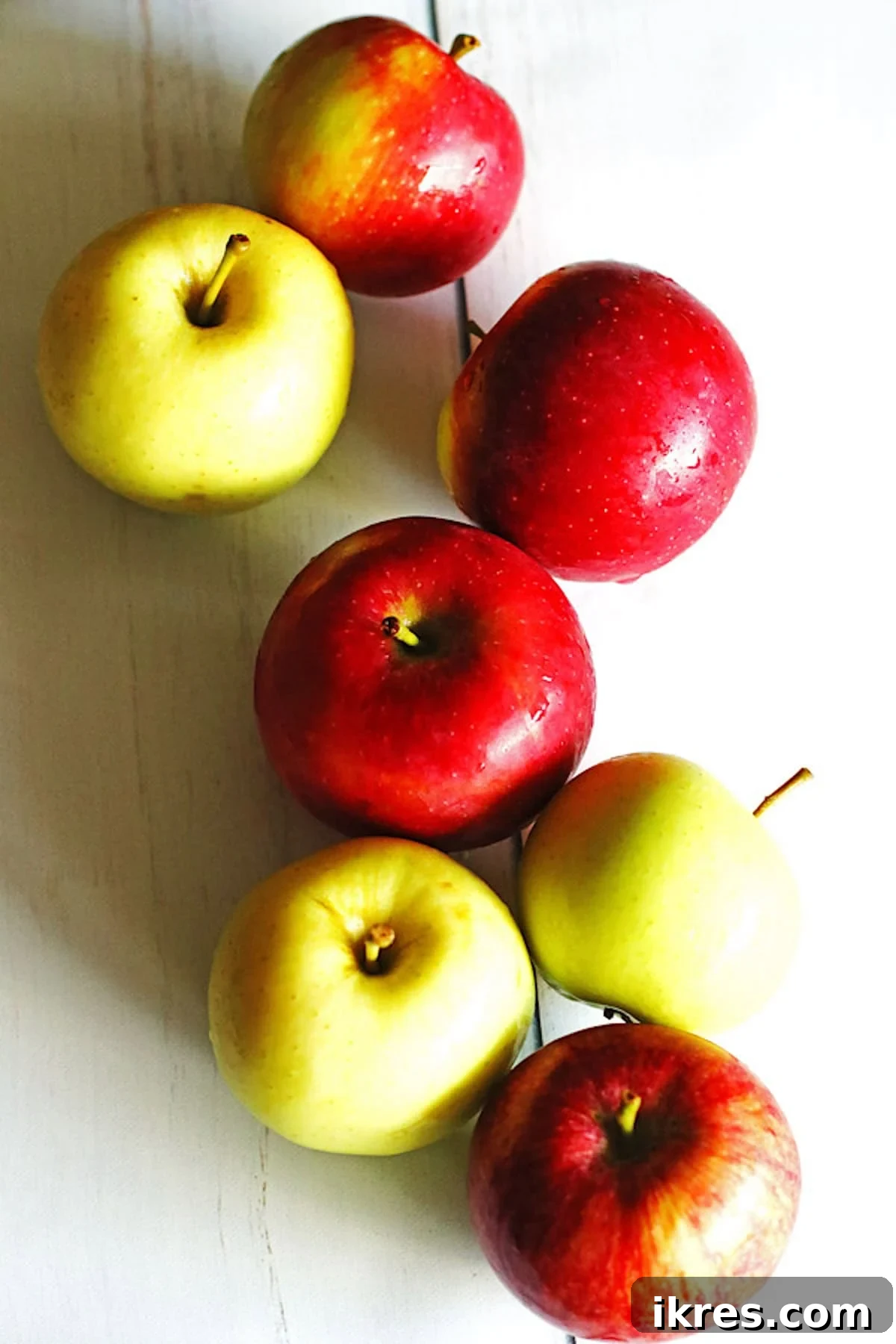 Berry Orchard Smoothie 3 A vibrant selection of red and green apples artfully arranged on a clean white table.
