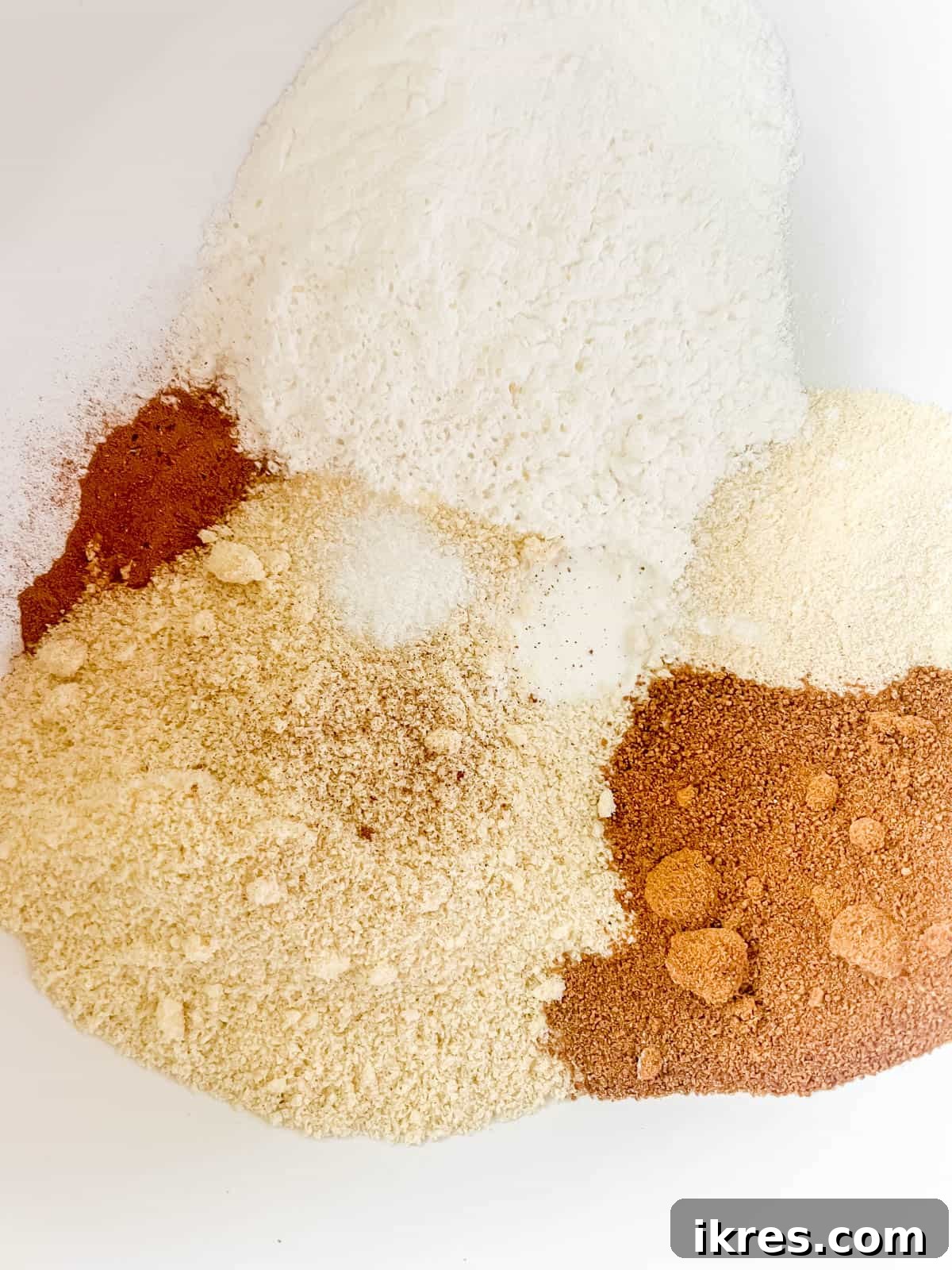Dry ingredients for the Paleo waffle recipe mixed together in a large mixing bowl.