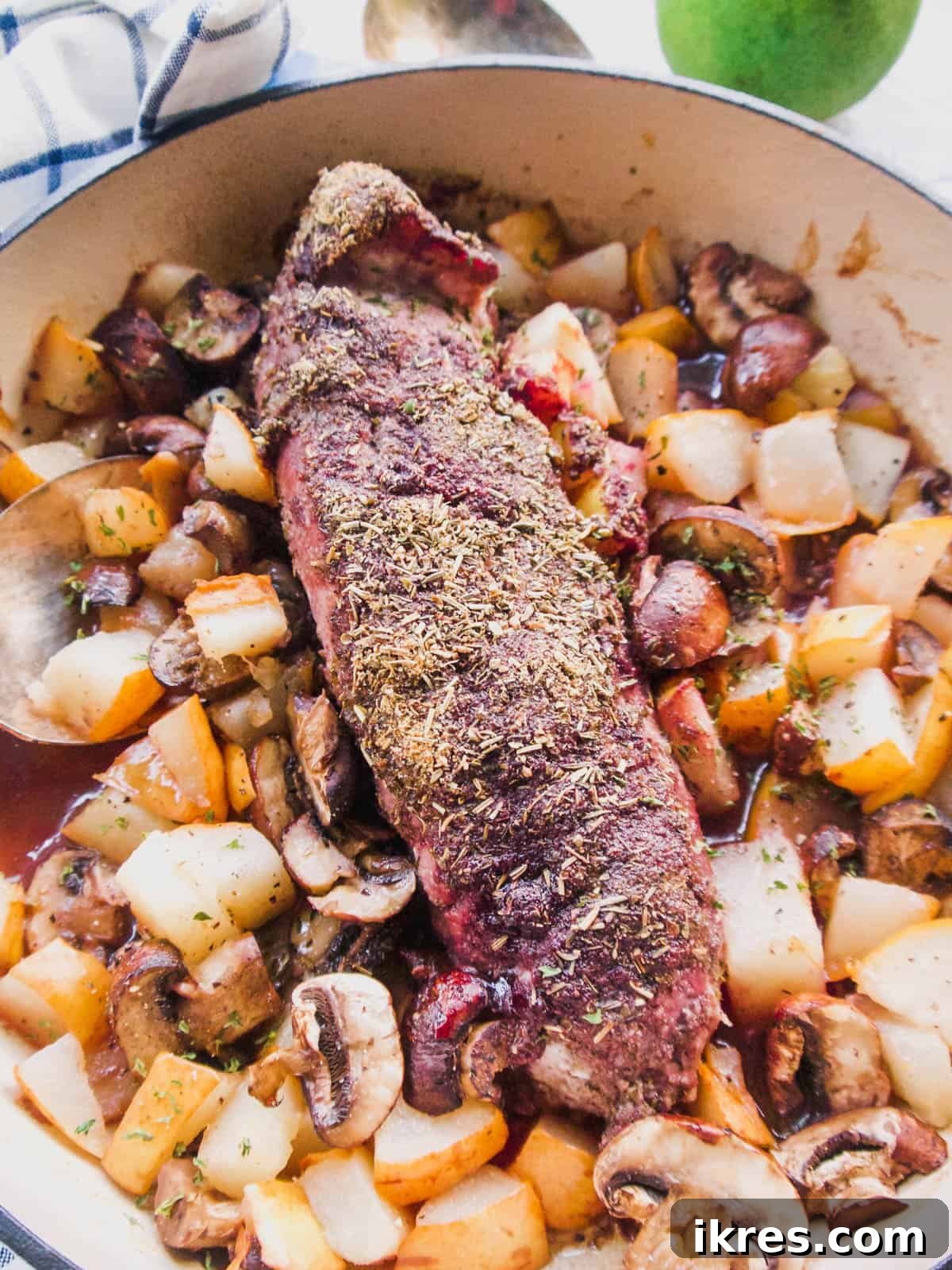 Dutch Oven Roasted Pork Loin with Sticky Spiced Fruit Glaze 2 Perfectly baked Dutch Oven Pork Loin covered in a glossy jam and spice crust, surrounded by tender pears and mushrooms.