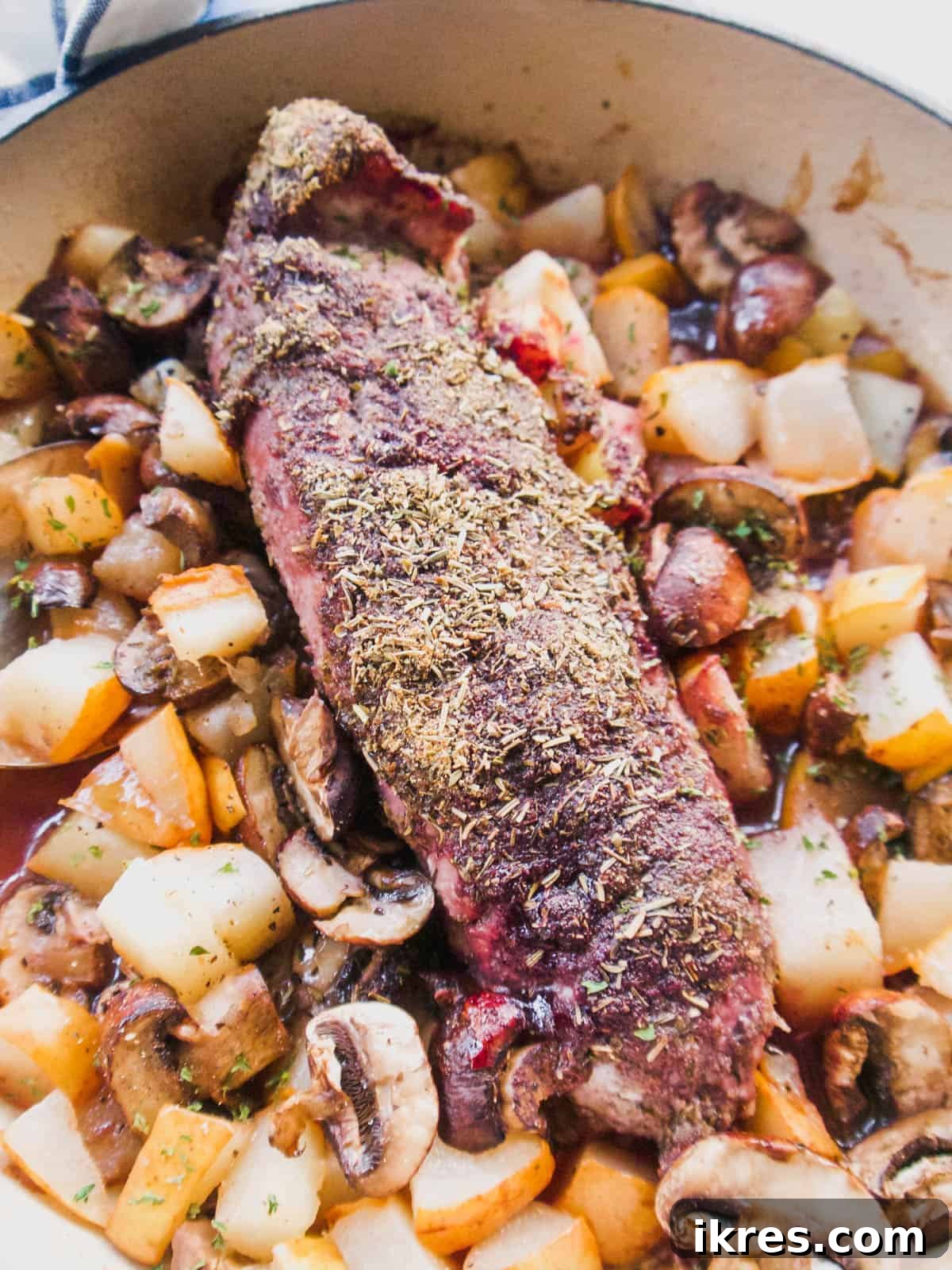 Dutch Oven Roasted Pork Loin with Sticky Spiced Fruit Glaze 7 The fully prepped Dutch oven with the jam and spice-crusted pork loin and seasoned fruits and vegetables, ready to go into the oven.
