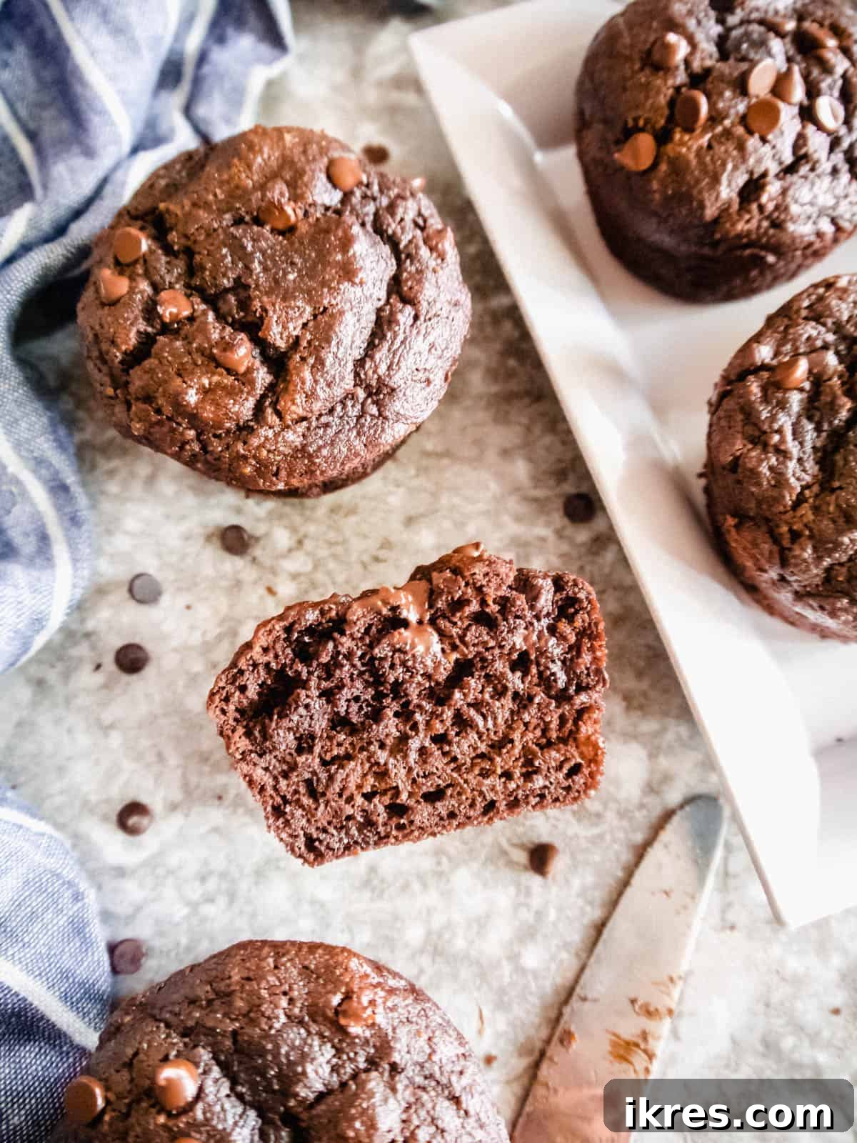 Wholesome Double Chocolate Banana Muffins Paleo Dairy Free Gluten Free 2 A Double Chocolate Banana muffin sliced in half, revealing its moist, chocolatey interior.