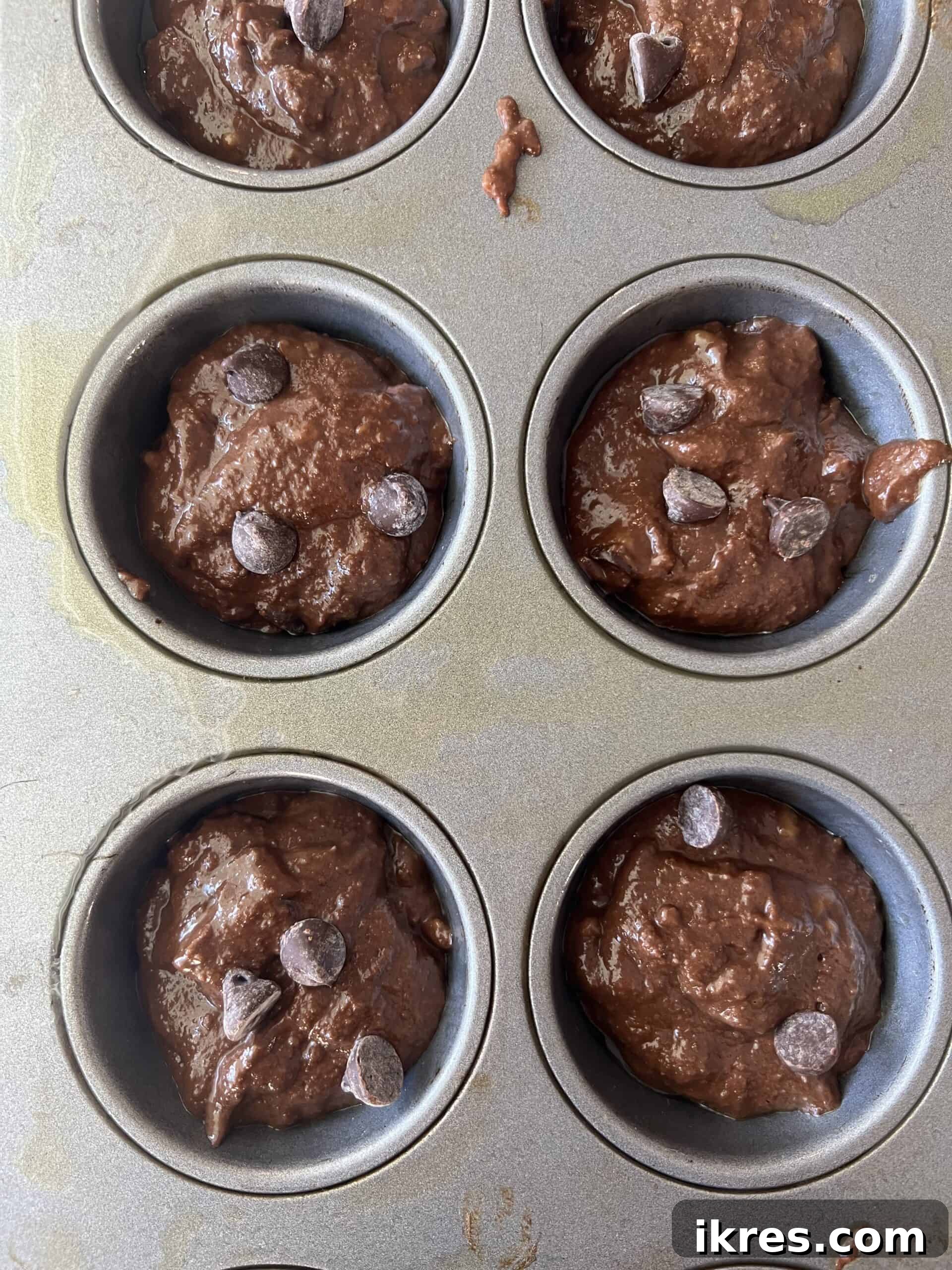 Wholesome Double Chocolate Banana Muffins Paleo Dairy Free Gluten Free 8 Double chocolate banana batter being scooped into muffin tins.