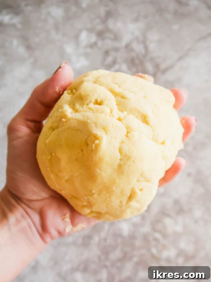 Simple Paleo Pie and Tart Crust Naturally Gluten and Dairy Free 7 Paleo tart crust dough being rolled into a ball by hand.