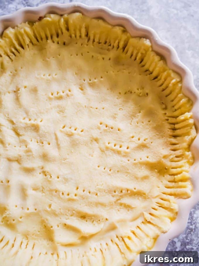 Simple Paleo Pie and Tart Crust Naturally Gluten and Dairy Free 8 Paleo pie crust pressed into a tart pan with fork holes.